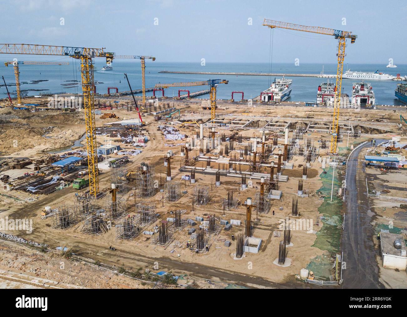 210305 -- HAIKOU, March 5, 2021 -- Aerial photo taken on March 5, 2021 shows the construction site of a passenger transportation station at the Xinhai Port in Haikou, south China s Hainan Province. The completion of this project will help improve the service level of the Xinhai Port in Haikou.  CHINA-HAINAN-HAIKOU-PORT-CONSTRUCTION CN PuxXiaoxu PUBLICATIONxNOTxINxCHN Stock Photo