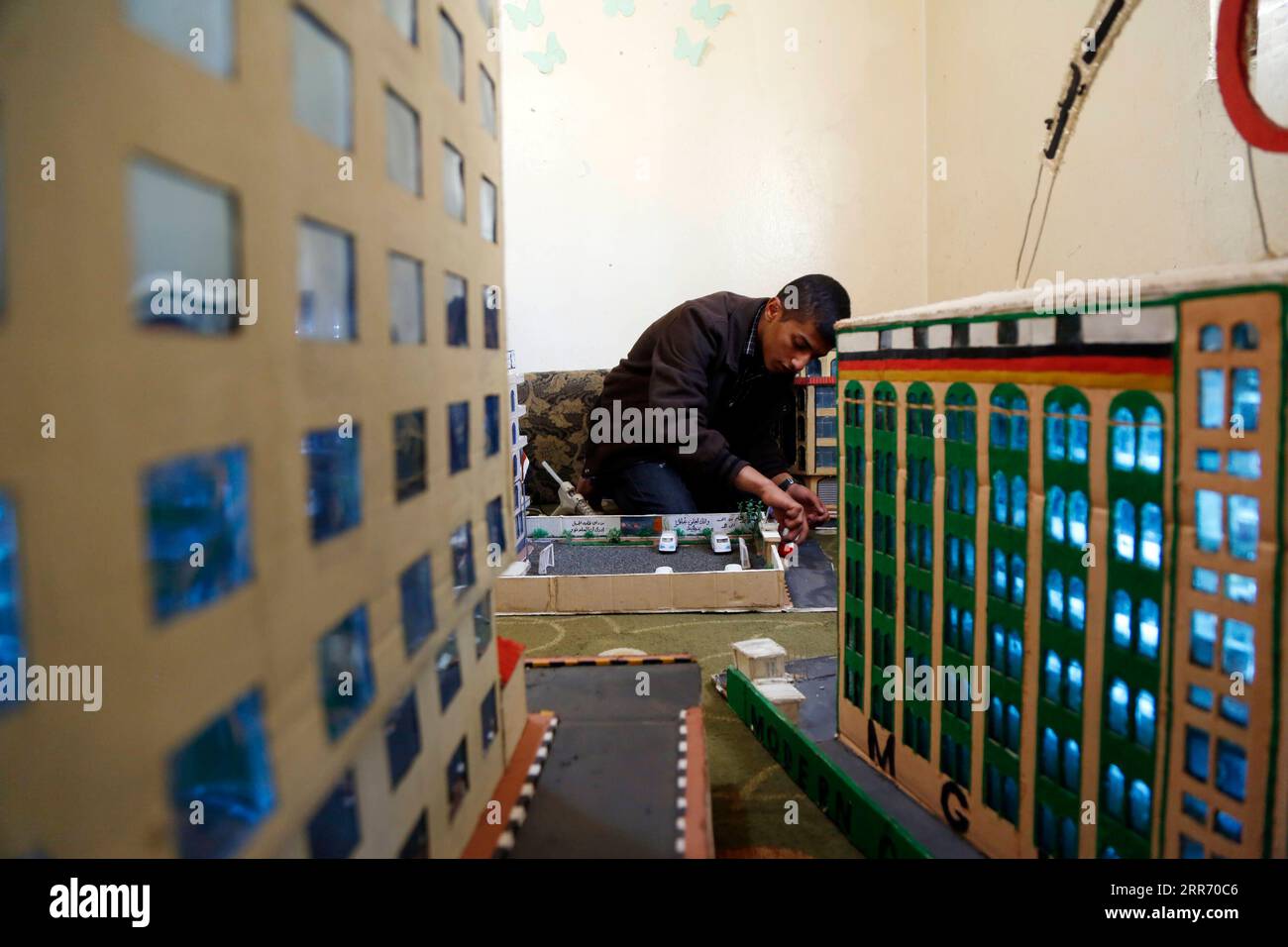 210306 -- SANAA, March 6, 2021 -- Musheer Al-Hzmi, makes building models inside his house in Sanaa, Yemen, on March 4, 2021. TO GO WITH Feature: Yemeni boy makes building models to recreate Sanna before war Photo by /Xinhua YEMEN-SANAA-BUILDING MODELS MohammedxMohammed PUBLICATIONxNOTxINxCHN Stock Photo