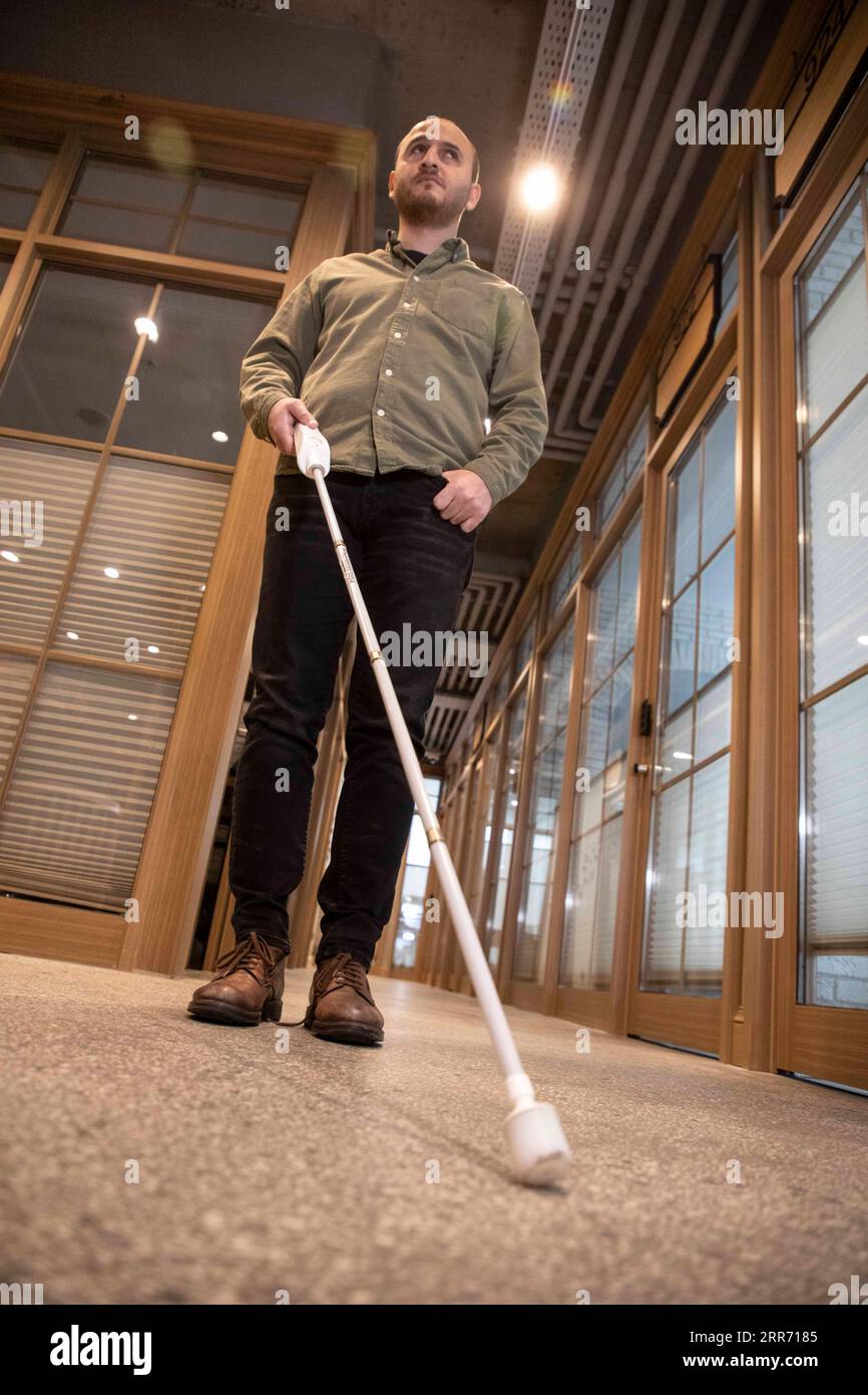210307 -- ISTANBUL, March 7, 2021 -- Kursat Ceylan demonstrates the smart cane We Walk in Istanbul, Turkey on March 2, 2021. The smart cane, developed by a Turkish start-up, can detect obstacles up to a certain height and warn its user with a vibration. Kursat Ceylan, a young man in his early 30s who has congenital blindness, leads the start-up that developed the smart cane. Photo by /Xinhua TO GO WITH Feature: Turkish smart cane navigates visually impaired through challenging life TURKEY-ISTANBUL-SMART CANE OsmanxOrsal PUBLICATIONxNOTxINxCHN Stock Photo