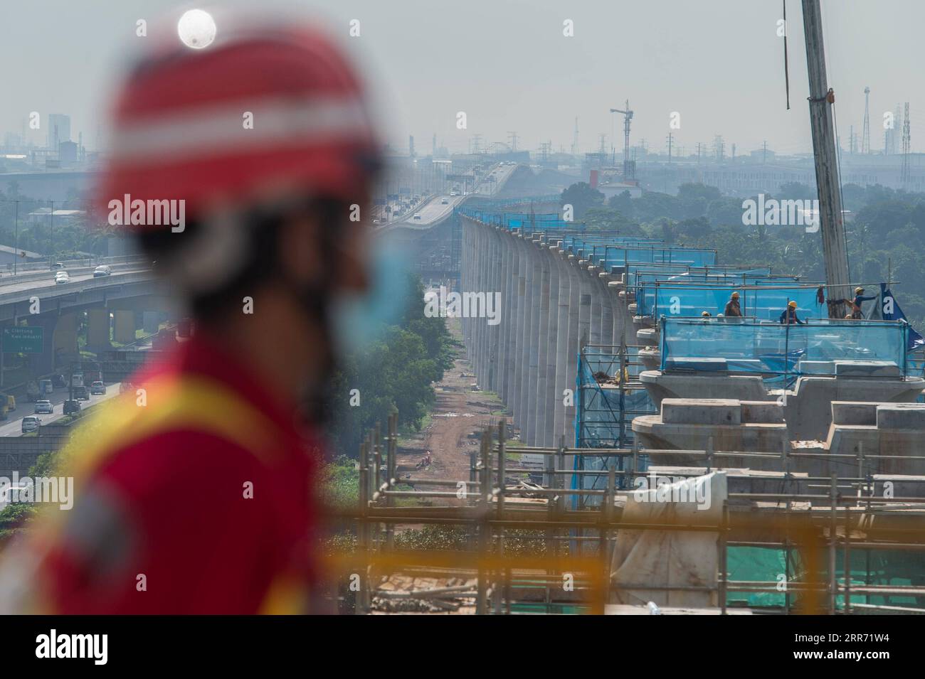 210308 -- JAKARTA, March 8, 2021 -- A worker stands on the largest span continuous beam of the Jakarta-Bandung High Speed Railway in Bekasi of Indonesia on March 8, 2021. The continuous beam with the largest span of Jakarta-Bandung High-Speed Railway HSR was successfully closed on Monday morning, marking the significant progress of another critical control project in the construction of the railway. A statement released by KCIC, a joint venture consortium by Chinese and Indonesian state-owned firms that runs the 142.3-km HSR, said the beam is closed in West Java province s Bekasi Regency and i Stock Photo