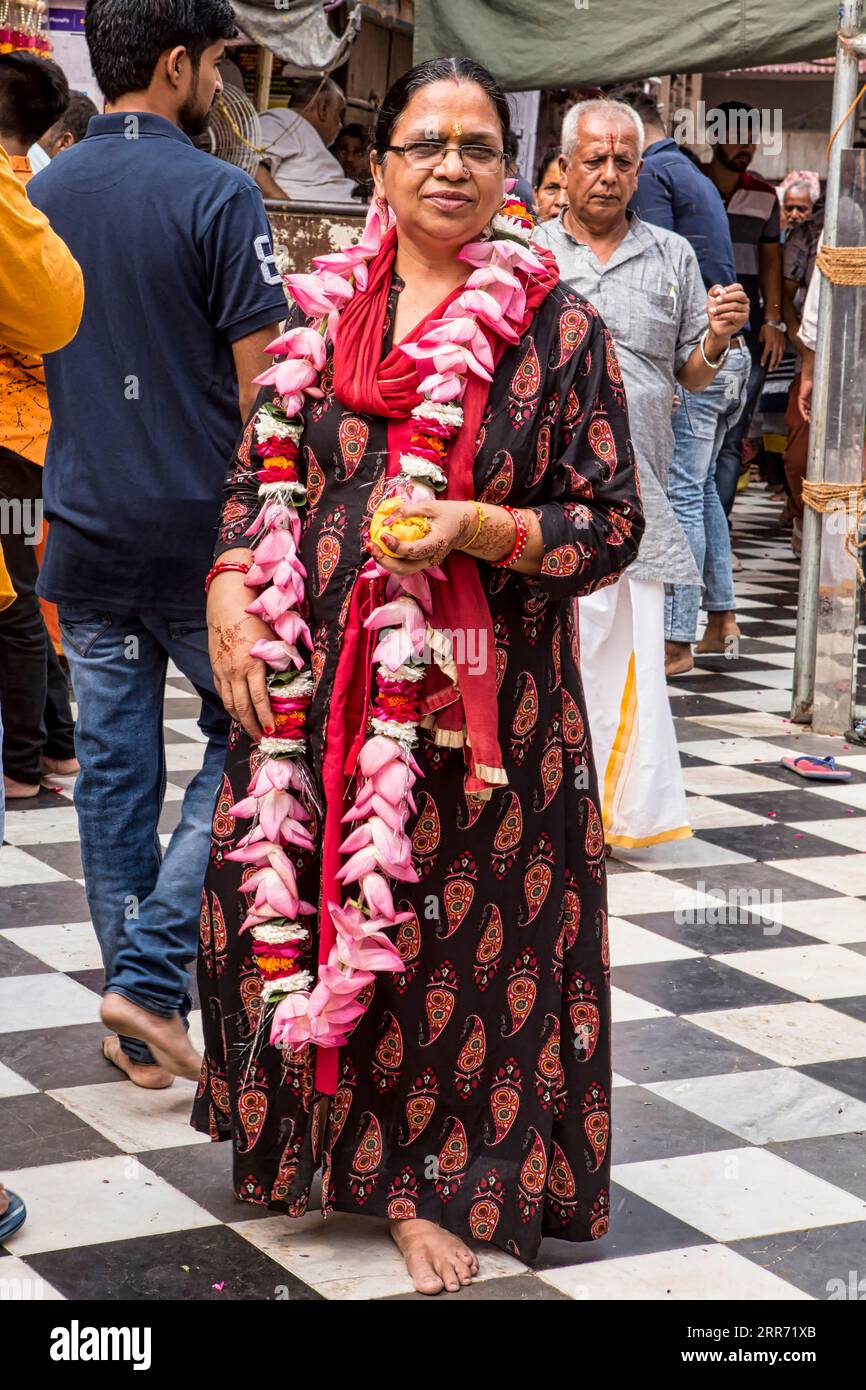 Vrindavan, Mathura, October 19th, 2020: One Hindu devotee woman standing with a garland on her neck outside Banke Bihari Temple in Vrindavan. Stock Photo