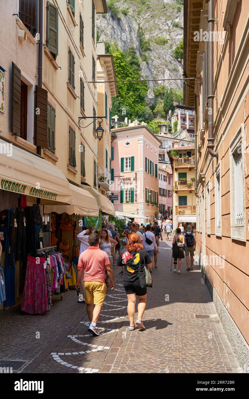 Holidaymakers in an alley of the popular old town of Limone Sul Garda on Lake Garda in Italy Stock Photo