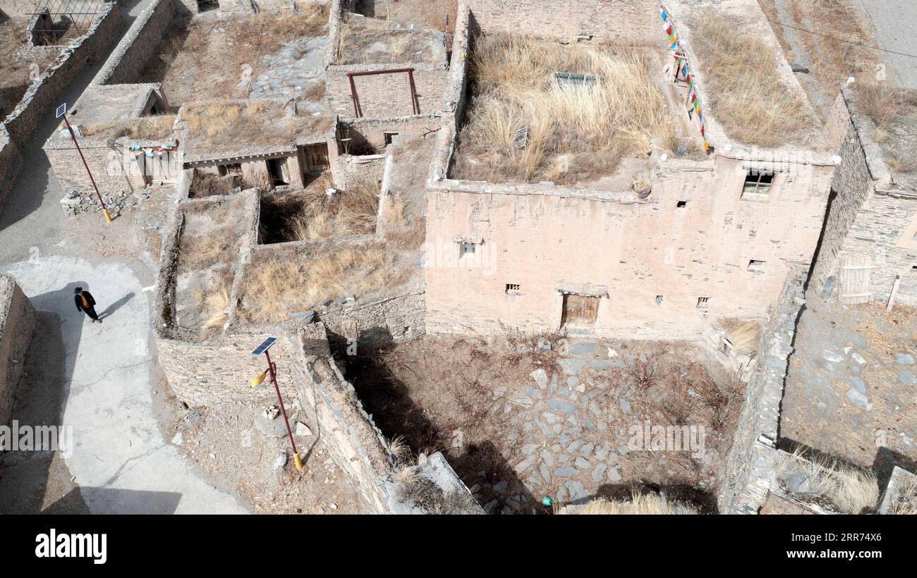 210312 -- YUSHU, March 12, 2021 -- Aerial photo taken on March 9, 2021 shows Nyima visiting an ancient castle in Lab Township of Chindu County, Yushu Tibetan Autonomous Prefecture, northwest China s Qinghai Province. Nyima, 40 years old, was born in a herdsman family in Chindu County of Yushu. His father is well known locally as a craftsman in traditional Tibetan architecture. Influenced by his father, Nyima showed great interest in traditional Tibetan architecture since his childhood. In 2010, a violent earthquake jolted Yushu and damaged many traditional Tibetan buildings, which made Nyima r Stock Photo