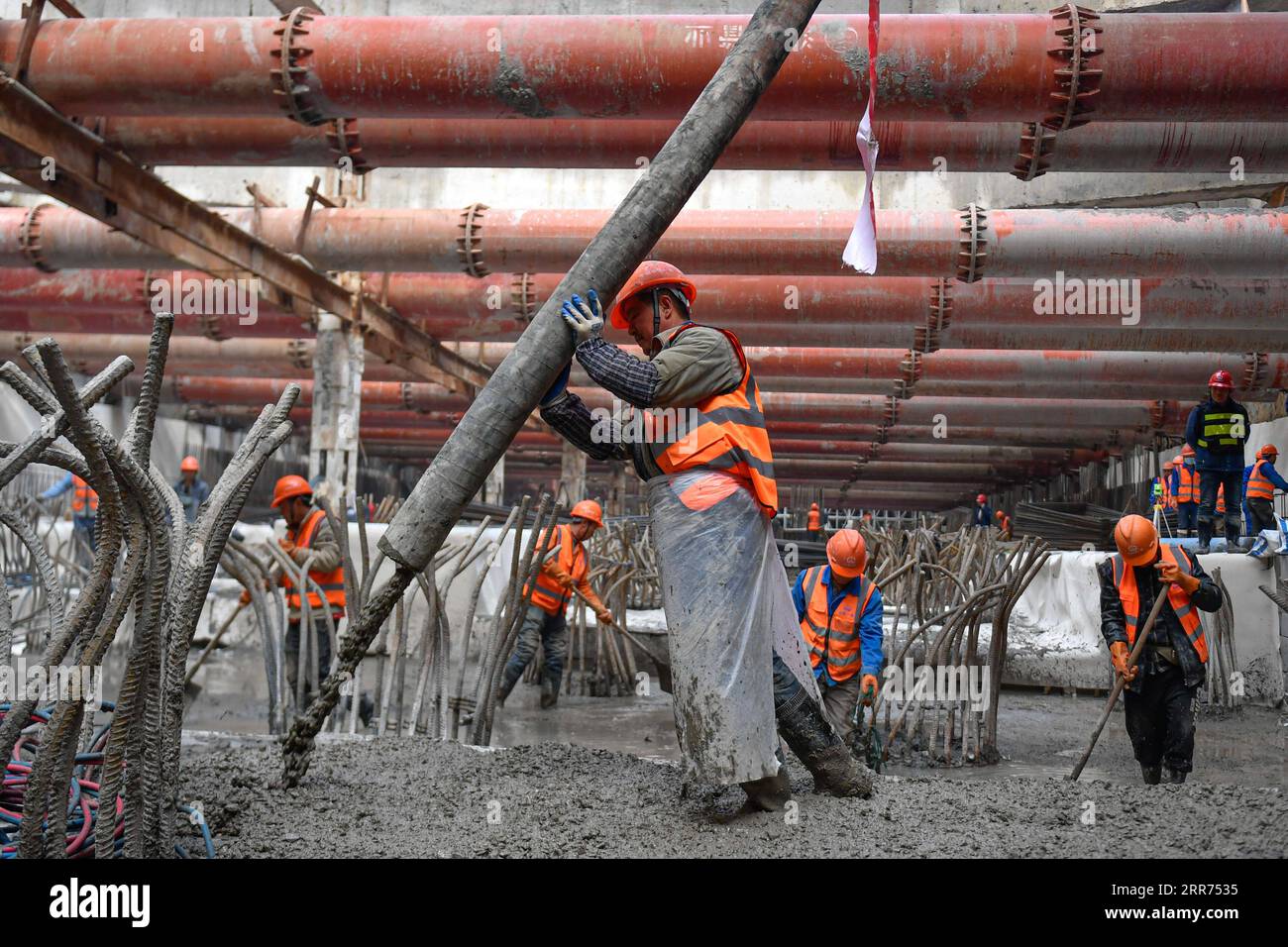 210312 -- HANGZHOU, March 12, 2021 -- Workers work at the construction site of Hangzhou West Railway Station in Hangzhou, capital of east China s Zhejiang Province, March 12, 2021. Hangzhou West Railway Station is a key support project for the 2022 Asian Games, and also a part of Hangzhou s grand plans to step up the infrastructure of the city. The construction of the comprehensive transportation hub that integrates multiple means of transportation is well underway.  CHINA-HANGZHOU-TRANSPORTATION HUB-CONSTRUCTION CN HuangxZongzhi PUBLICATIONxNOTxINxCHN Stock Photo