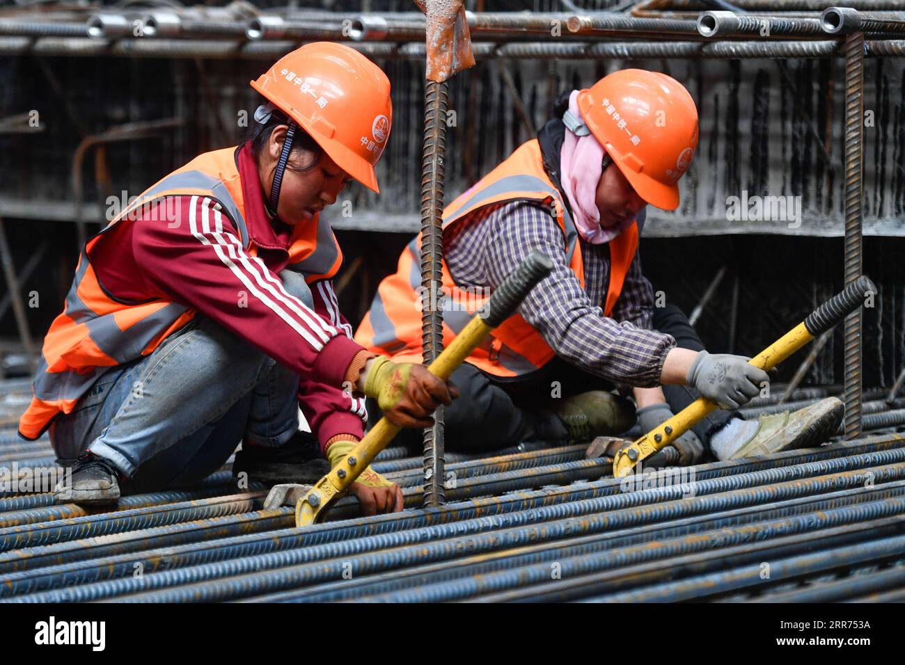 210312 -- HANGZHOU, March 12, 2021 -- Workers work at the construction site of Hangzhou West Railway Station in Hangzhou, capital of east China s Zhejiang Province, March 12, 2021. Hangzhou West Railway Station is a key support project for the 2022 Asian Games, and also a part of Hangzhou s grand plans to step up the infrastructure of the city. The construction of the comprehensive transportation hub that integrates multiple means of transportation is well underway.  CHINA-HANGZHOU-TRANSPORTATION HUB-CONSTRUCTION CN HuangxZongzhi PUBLICATIONxNOTxINxCHN Stock Photo