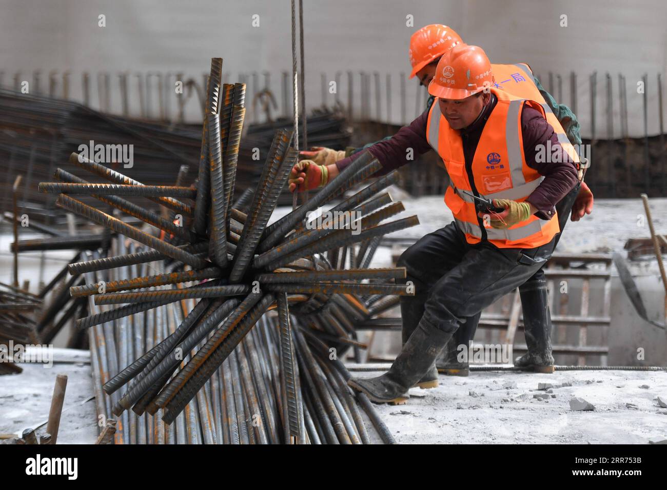 210312 -- HANGZHOU, March 12, 2021 -- Workers work at the construction site of Hangzhou West Railway Station in Hangzhou, capital of east China s Zhejiang Province, March 12, 2021. Hangzhou West Railway Station is a key support project for the 2022 Asian Games, and also a part of Hangzhou s grand plans to step up the infrastructure of the city. The construction of the comprehensive transportation hub that integrates multiple means of transportation is well underway.  CHINA-HANGZHOU-TRANSPORTATION HUB-CONSTRUCTION CN HuangxZongzhi PUBLICATIONxNOTxINxCHN Stock Photo