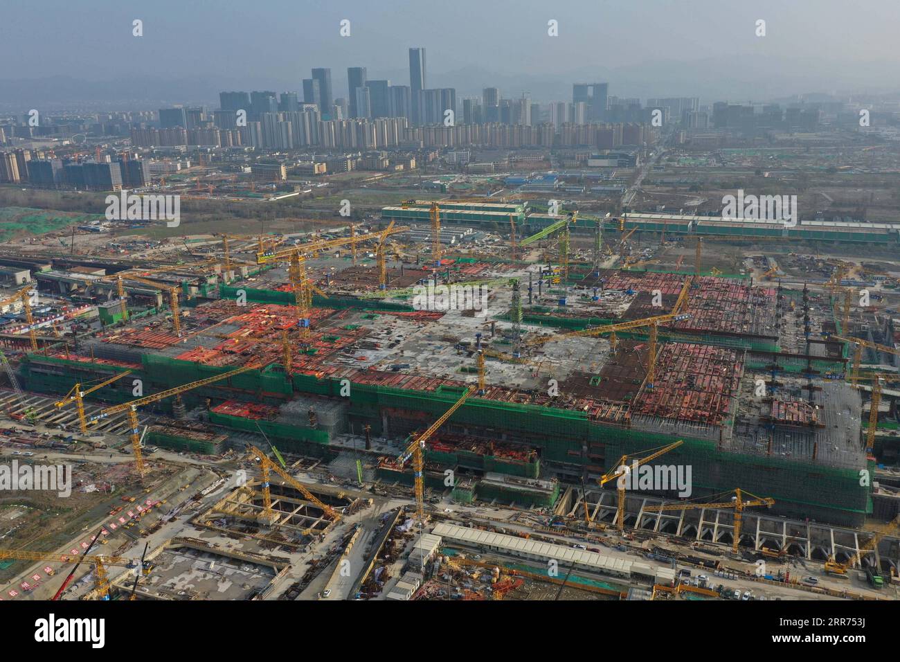 210312 -- HANGZHOU, March 12, 2021 -- Aerial photo taken on March 12, 2021 shows the construction site of Hangzhou West Railway Station in Hangzhou, capital of east China s Zhejiang Province. Hangzhou West Railway Station is a key support project for the 2022 Asian Games, and also a part of Hangzhou s grand plans to step up the infrastructure of the city. The construction of the comprehensive transportation hub that integrates multiple means of transportation is well underway.  CHINA-HANGZHOU-TRANSPORTATION HUB-CONSTRUCTION CN HuangxZongzhi PUBLICATIONxNOTxINxCHN Stock Photo