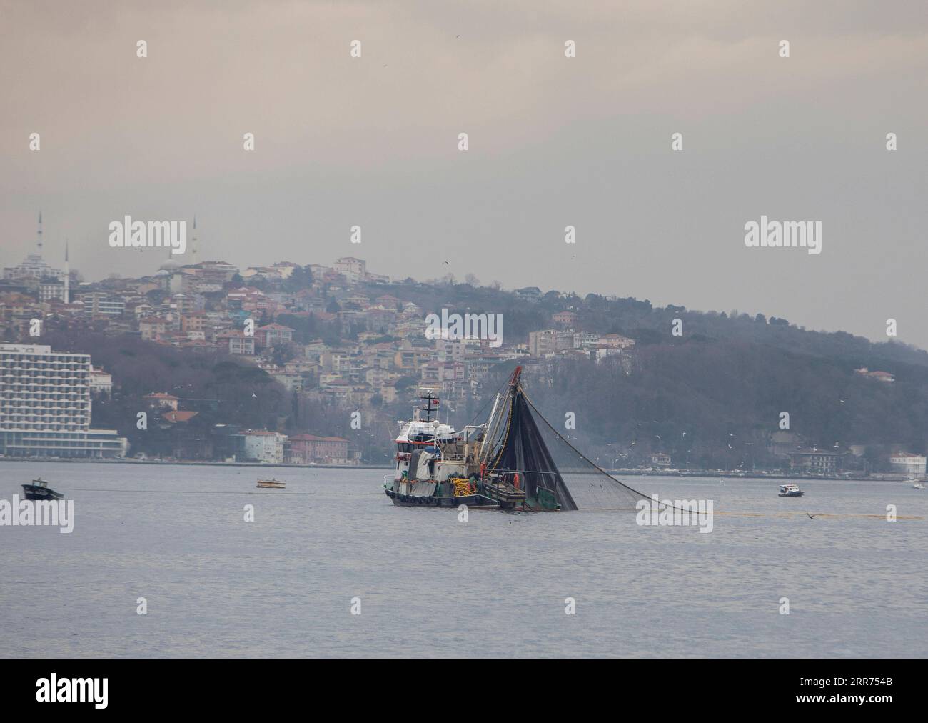 210312 -- ISTANBUL, March 12, 2021 -- A fishing boat is seen on the Black Sea in Istanbul, Turkey, on March 6, 2021. The Black Sea is packed with local bottom fishes, including haddock, mullet, and turbot. There are also migrating fishes from the Atlantic Sea, such as bonito, bluefish, anchovy, and horse-mackerel. However, climate change, overfishing, and other natural causes have had tremendous adverse impacts on the stocks of fisheries and aquaculture. Restrictions related to the COVID-19 pandemic, as well as the rising costs of labor, fuel, and equipment also preoccupy the fishermen. Photo Stock Photo