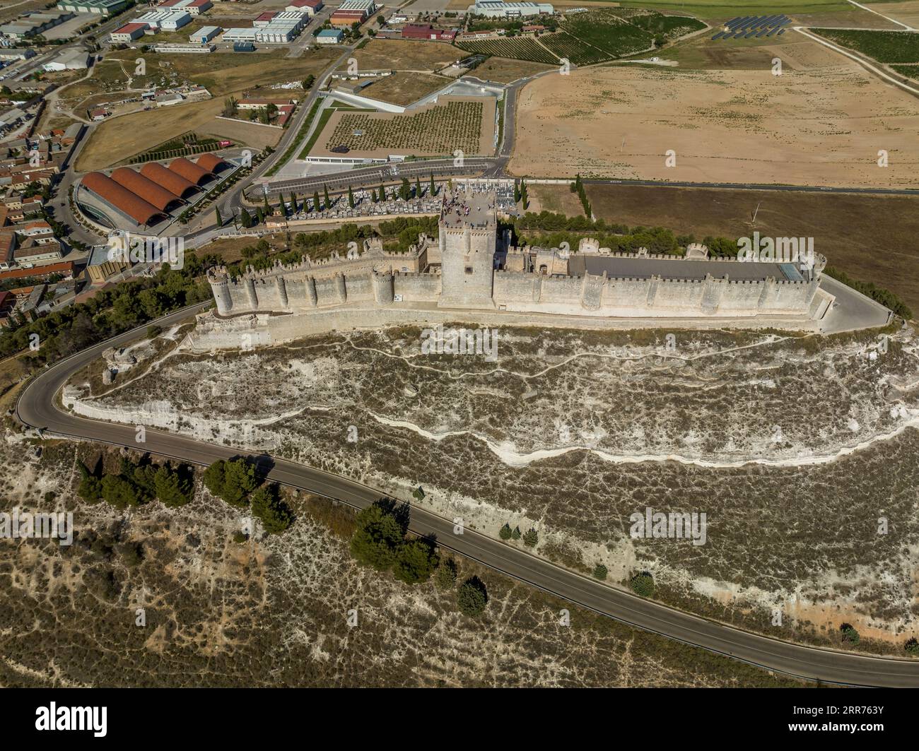 Aerial panorama view of Penafiel castle in Spain, with blue sky background, long walls enclose the top of the hill, three storey keep and turrets Stock Photo