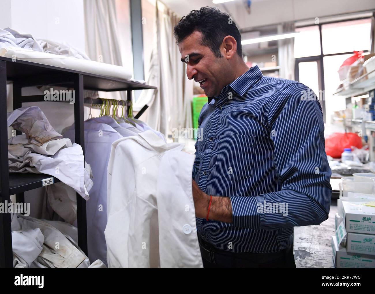 210318 -- XI AN, March 18, 2021 -- Abdul Ghaffar Shar makes preparation for an experiment at a laboratory of Northwest Agriculture and Forestry University NWAFU in Yangling, northwest China s Shaanxi Province, March 17, 2021. Abdul Ghaffar Shar, 30, is a Pakistani doctoral student in China s Northwest Agriculture and Forestry University NWAFU. Shar is doing plant nutrition research for his doctoral degree. After receiving his bachelor s degree in agriculture from Sindh Agriculture University in Pakistan in 2014, Shar decided to further his studies in China s NWAFU. Shar has learned to speak Ma Stock Photo