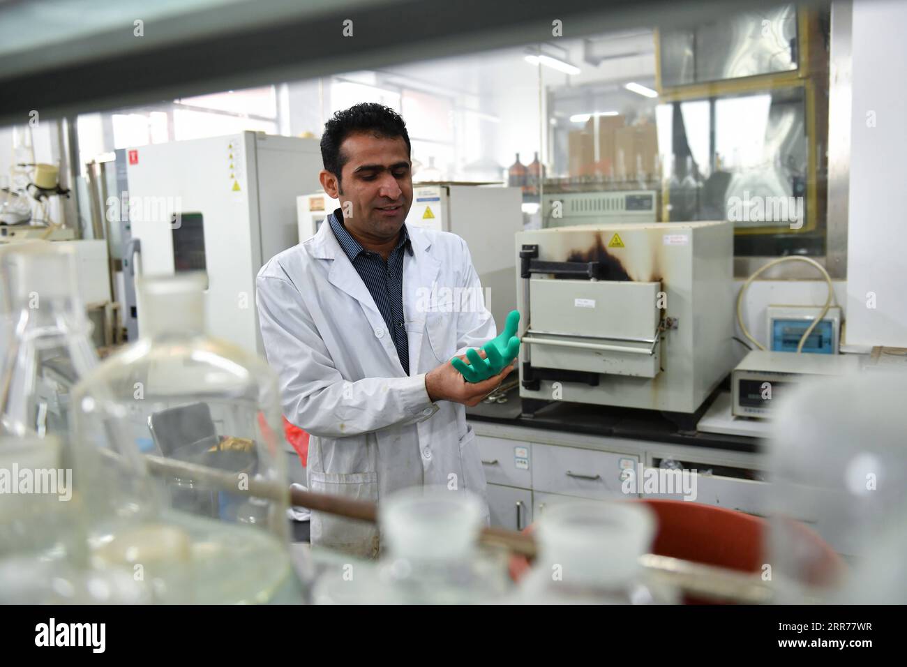 210318 -- XI AN, March 18, 2021 -- Abdul Ghaffar Shar makes preparation for an experiment at a laboratory of Northwest Agriculture and Forestry University NWAFU in Yangling, northwest China s Shaanxi Province, March 17, 2021. Abdul Ghaffar Shar, 30, is a Pakistani doctoral student in China s Northwest Agriculture and Forestry University NWAFU. Shar is doing plant nutrition research for his doctoral degree. After receiving his bachelor s degree in agriculture from Sindh Agriculture University in Pakistan in 2014, Shar decided to further his studies in China s NWAFU. Shar has learned to speak Ma Stock Photo