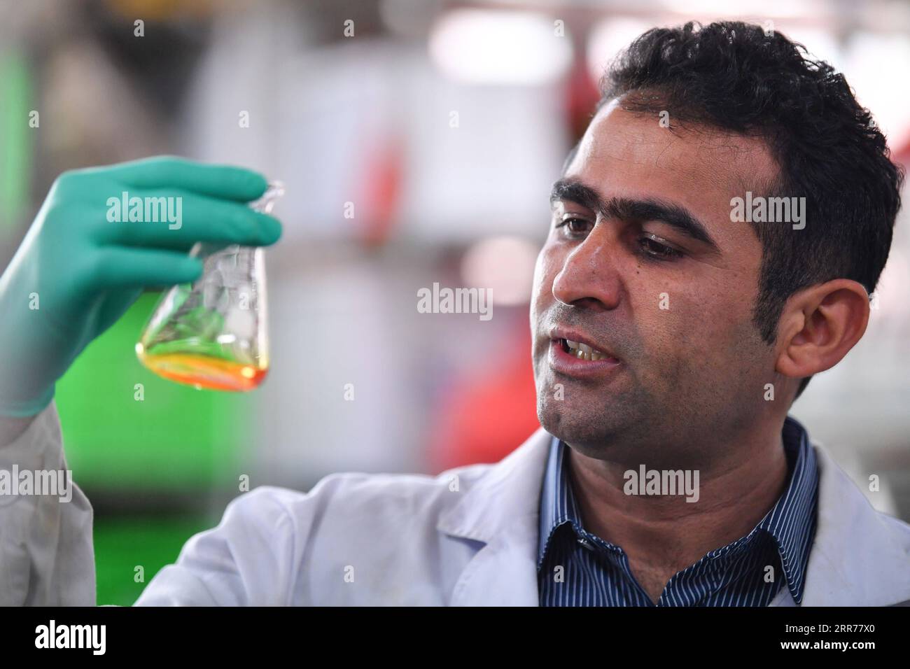 210318 -- XI AN, March 18, 2021 -- Abdul Ghaffar Shar conducts an experiment at a laboratory of Northwest Agriculture and Forestry University NWAFU in Yangling, northwest China s Shaanxi Province, March 17, 2021. Abdul Ghaffar Shar, 30, is a Pakistani doctoral student in China s Northwest Agriculture and Forestry University NWAFU. Shar is doing plant nutrition research for his doctoral degree. After receiving his bachelor s degree in agriculture from Sindh Agriculture University in Pakistan in 2014, Shar decided to further his studies in China s NWAFU. Shar has learned to speak Mandarin and us Stock Photo