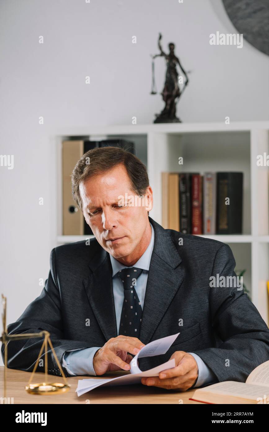 Male lawyer inspecting contract court room Stock Photo