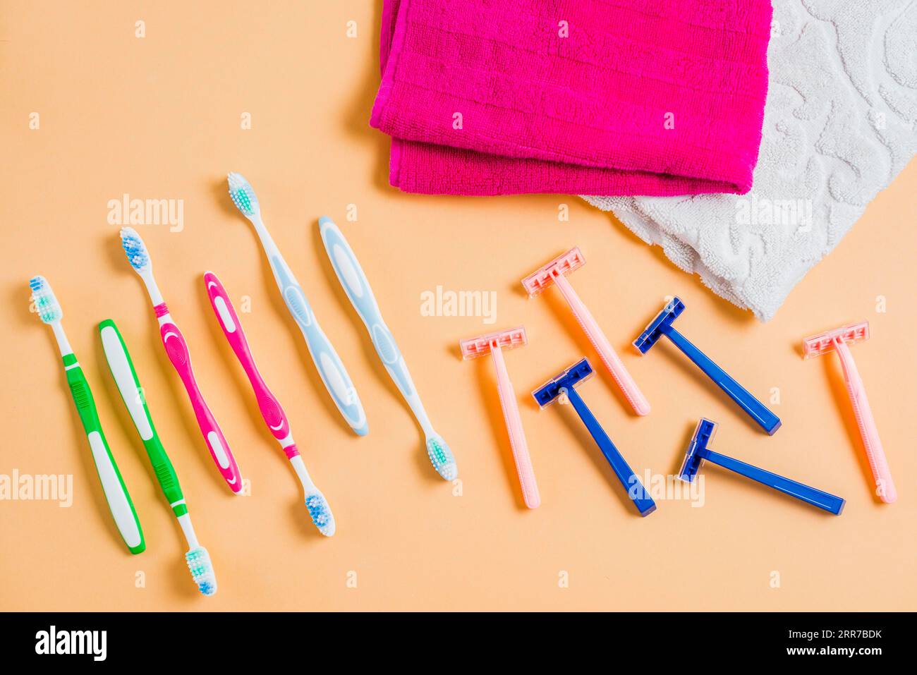 Plastic razor with tooth brushes towel colored background Stock Photo ...