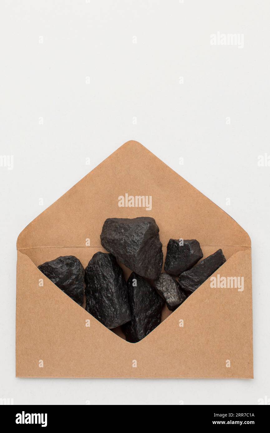 Top view envelope filled with coal ore Stock Photo