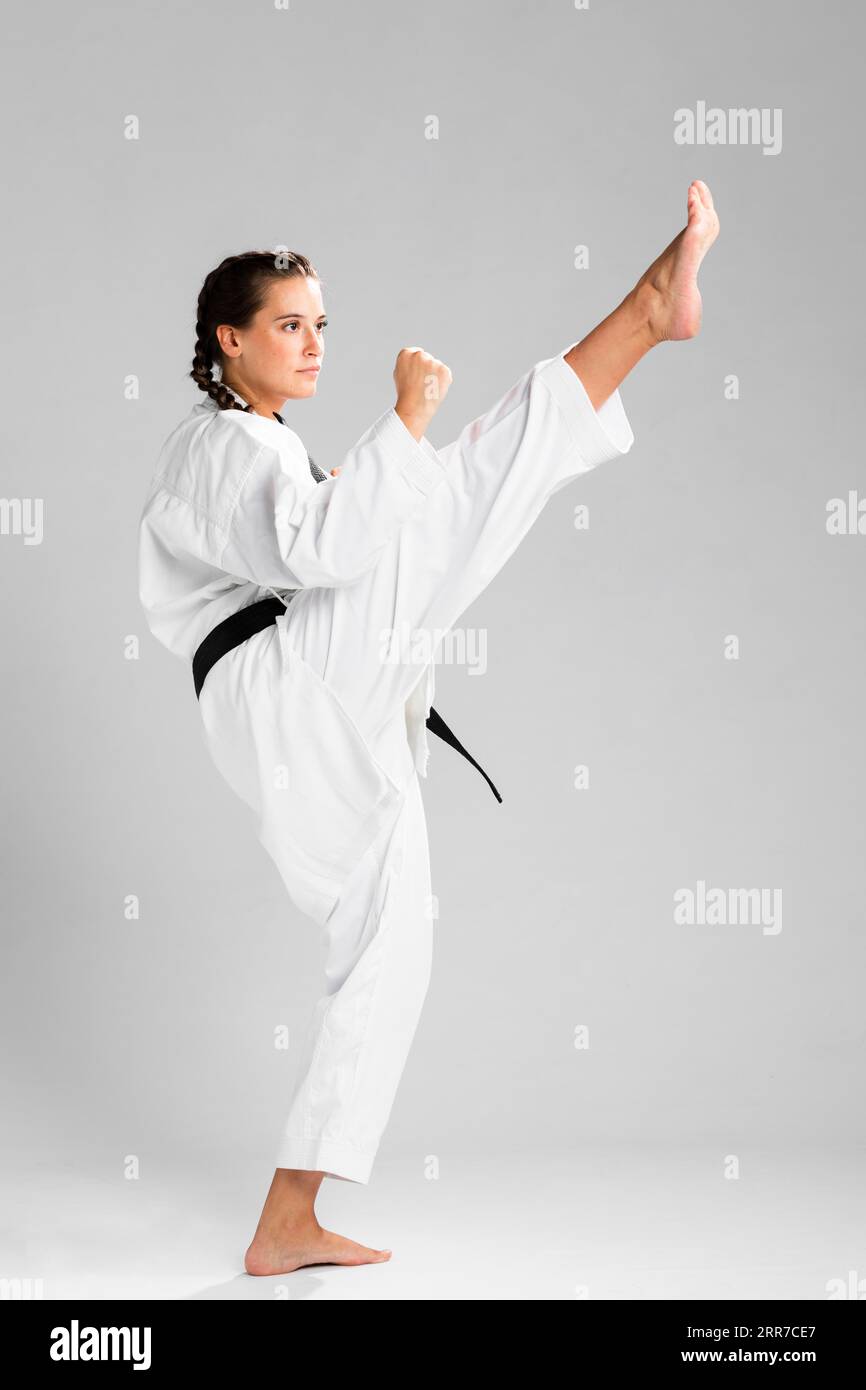 Young adult woman with black belt fighter training karate Stock Photo