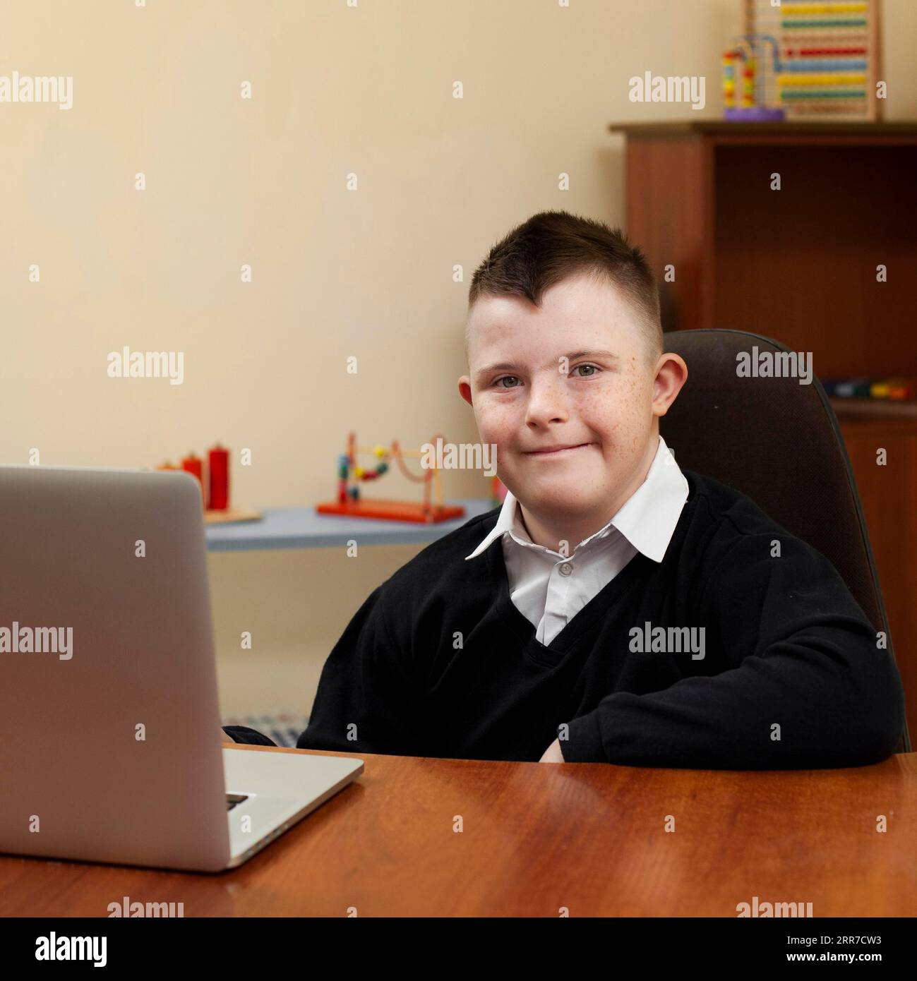 Boy with down syndrome posing with laptop Stock Photo Alamy