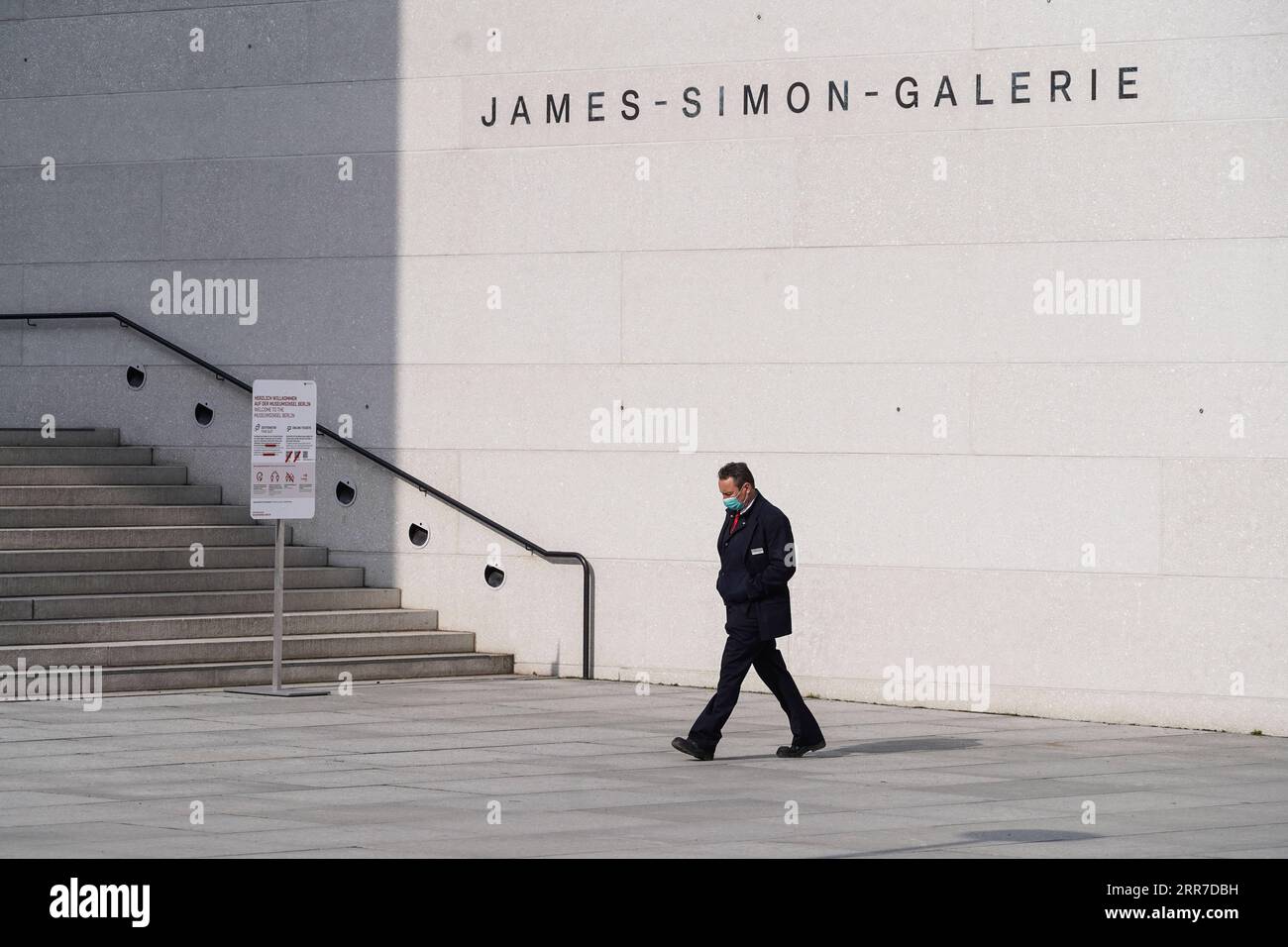 210326 -- BERLIN, March 26, 2021 -- A staff member walks past the James Simon Gallery in Berlin, capital of Germany, March 25, 2021. Daily COVID-19 infections in Germany rose sharply as 22,657 new cases were registered within one day, about 5,100 more than one week ago, the Robert Koch Institute RKI said Thursday. The country s seven-day COVID-19 incidence rate also rose from 108.1 per 100,000 people in the previous day to 113.3 Thursday, according to the federal government agency for disease control and prevention. Photo by /Xinhua GERMANY-BERLIN-COVID-19-CASES StefanxZeitz PUBLICATIONxNOTxIN Stock Photo
