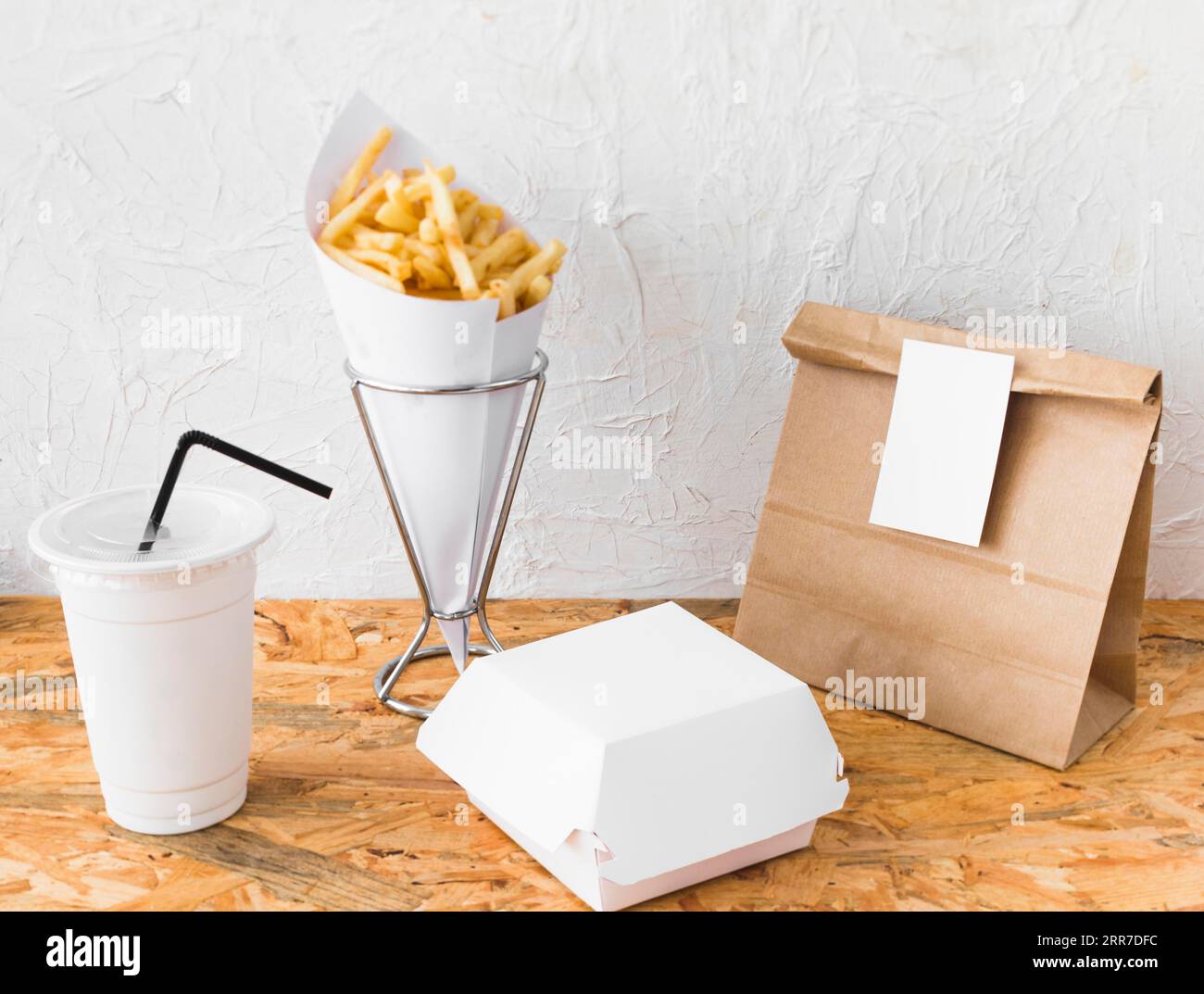 French fries disposal cup food parcel wooden surface Stock Photo