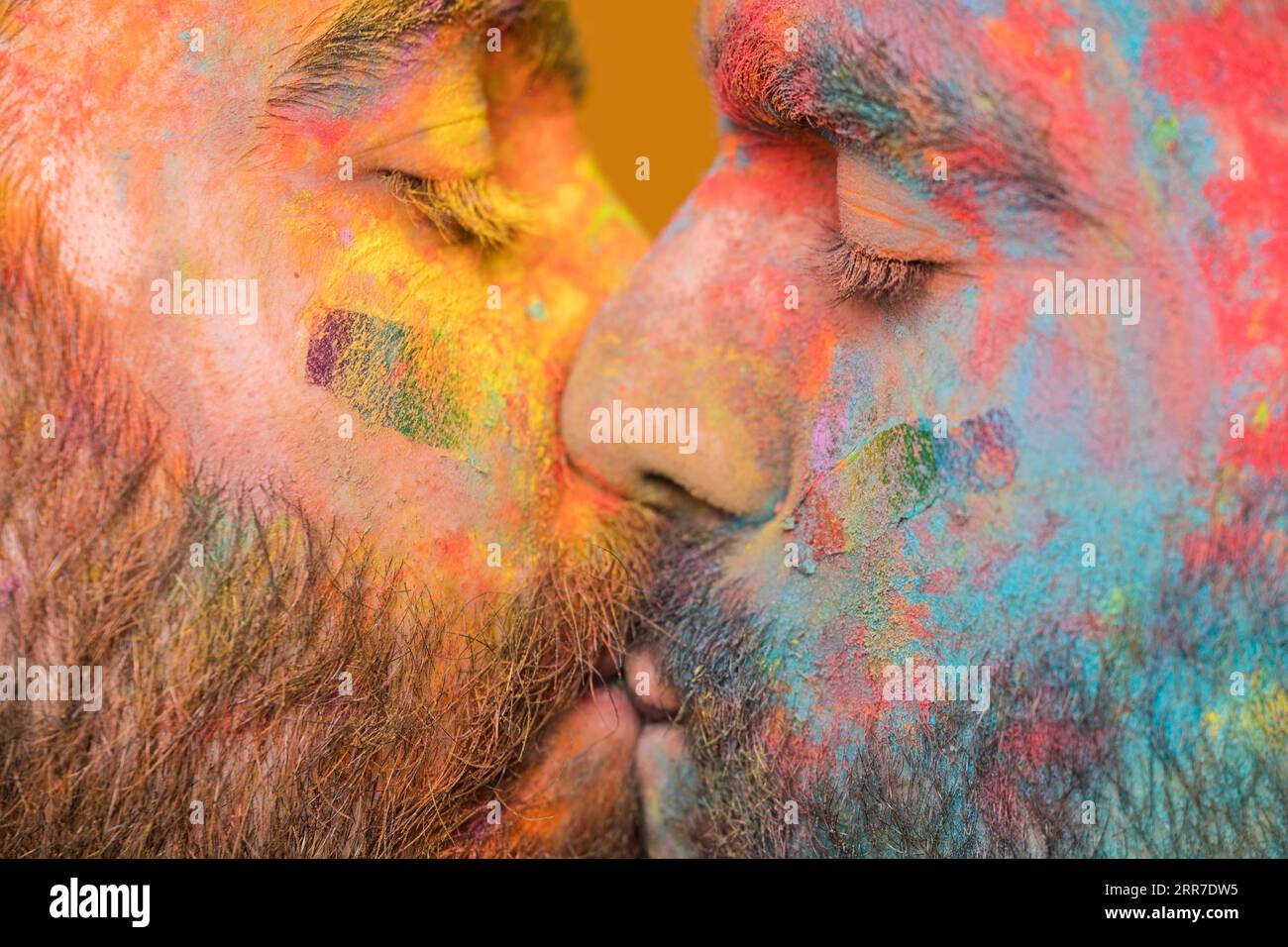 Kissing couple rainbow painted homosexual men Stock Photo