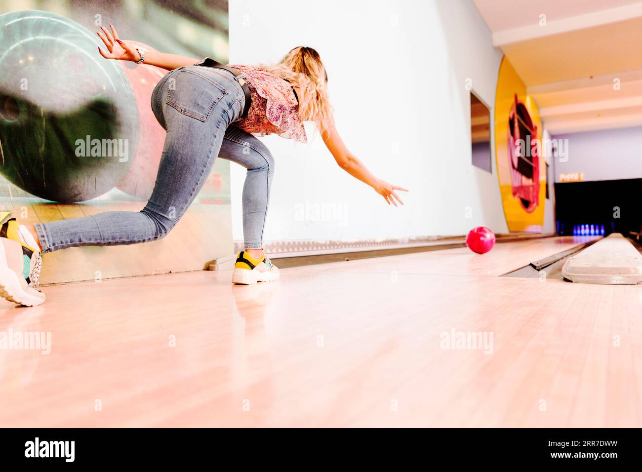 Low view woman throwing bowling ball Stock Photo Alamy