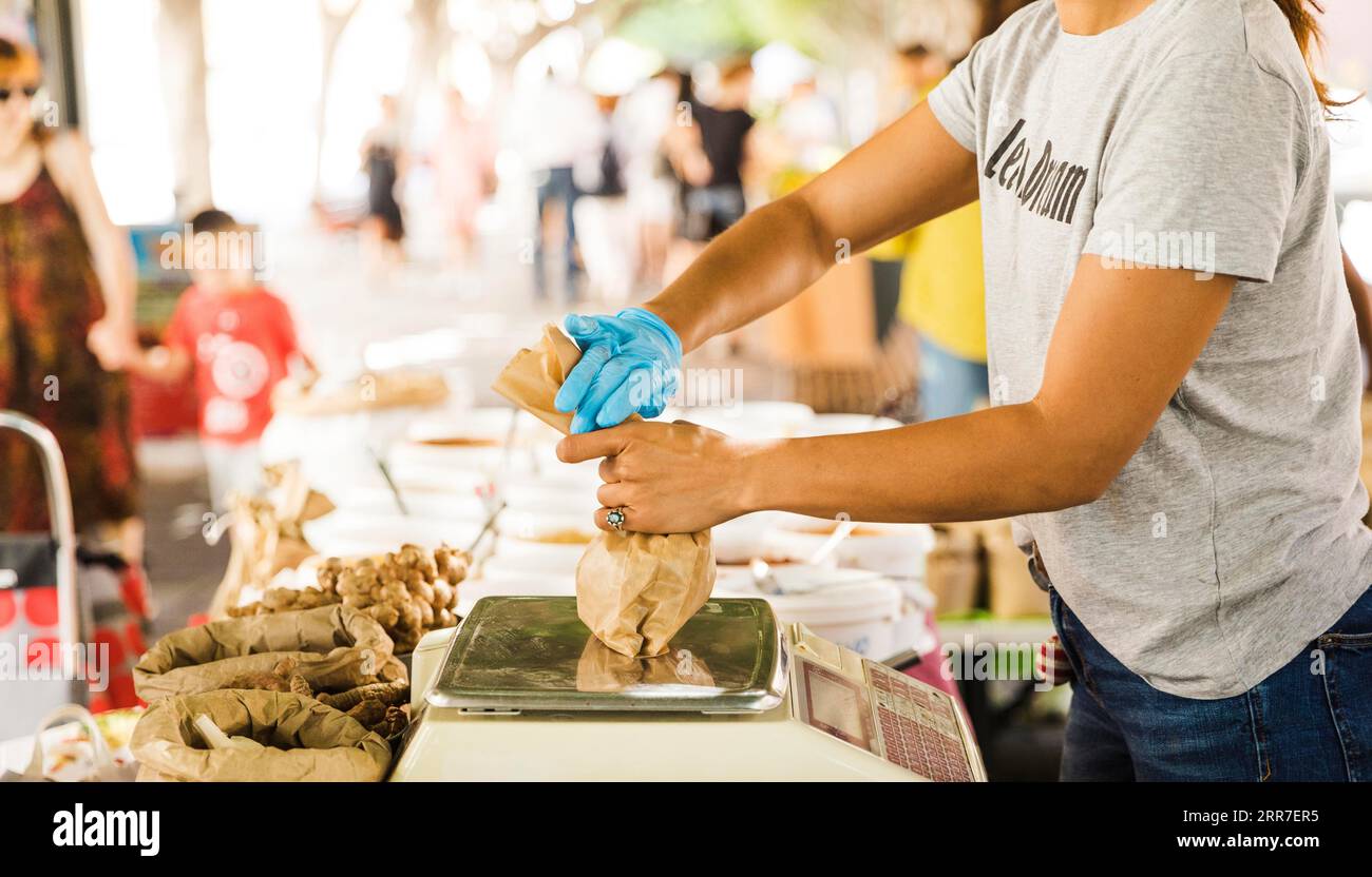 Woman seller packing food her customer market Stock Photo