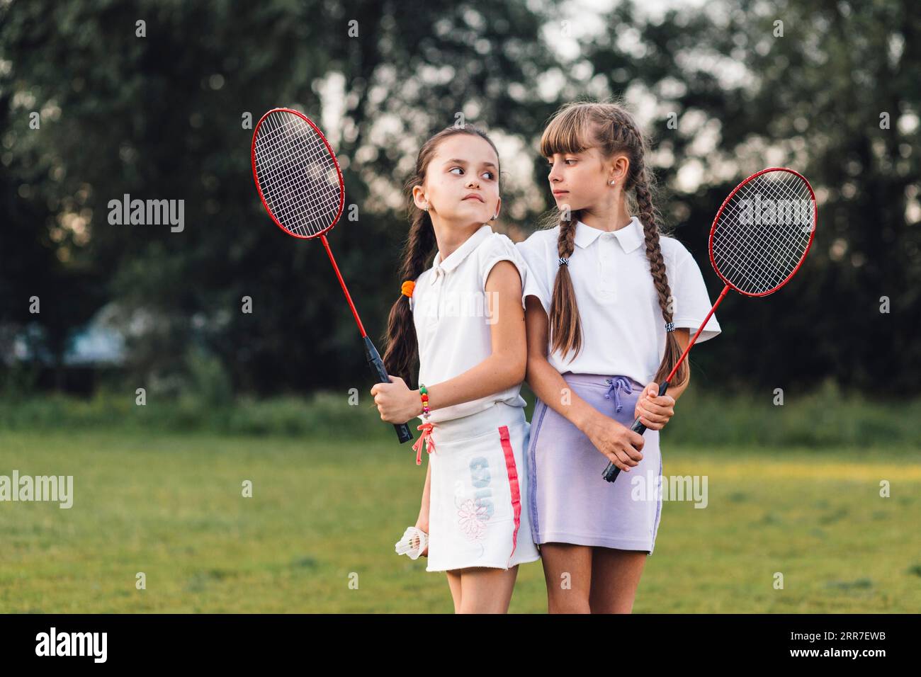 Angry girls holding badminton hand looking each other Stock Photo