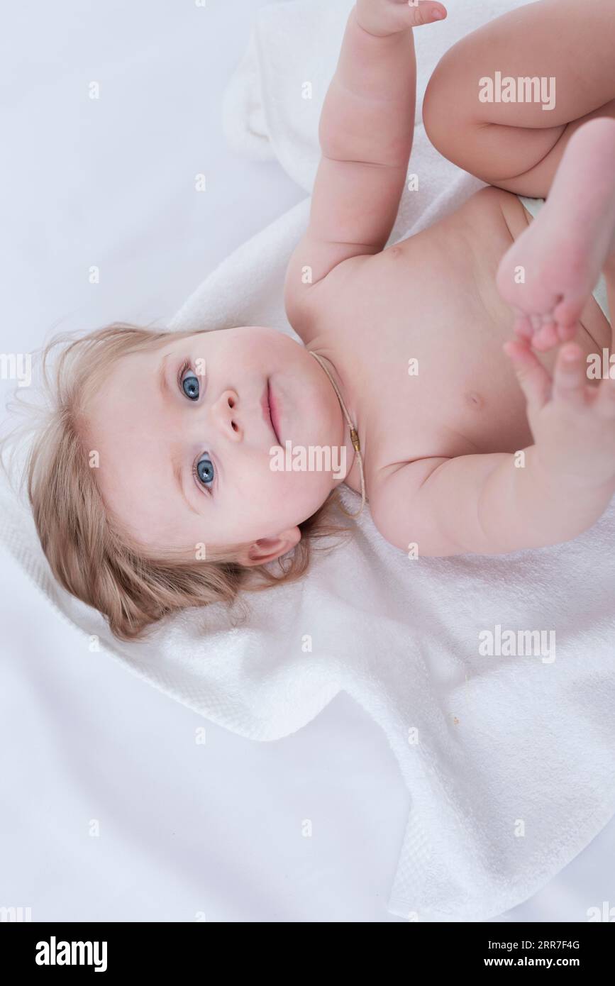 Baby posing with white towel Stock Photo