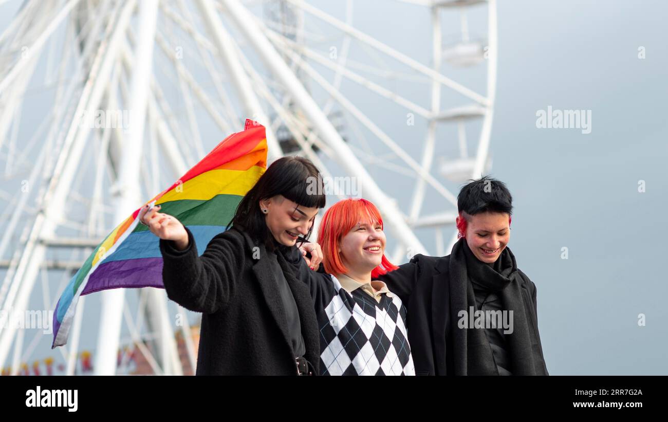 Group non binary people with lgbt flag Stock Photo