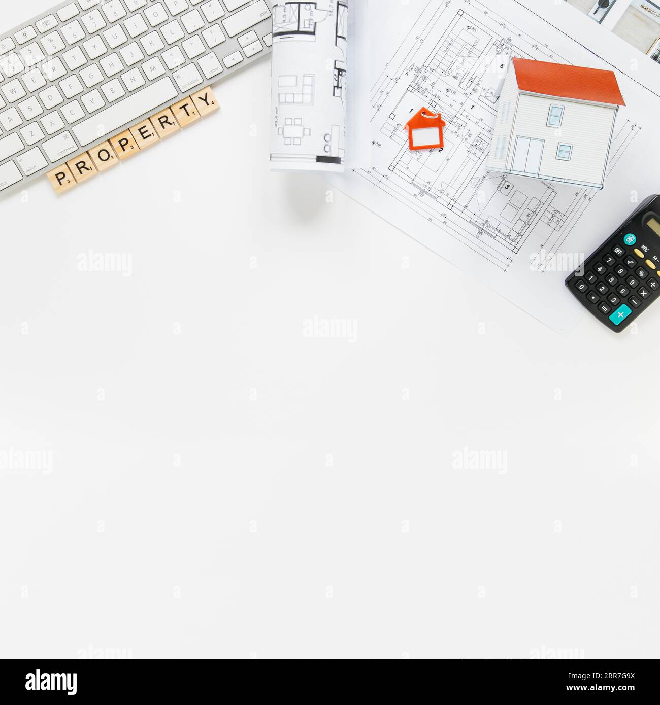 Keyboard with house model blueprint real estate office desk Stock Photo