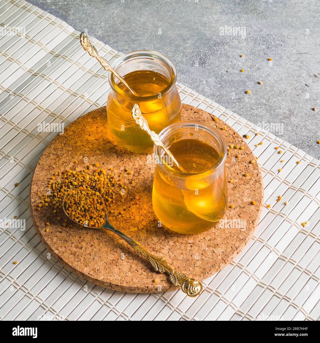Two honey pots with bee pollens circular cork coaster Stock Photo