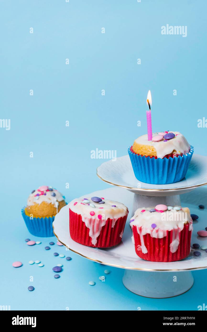 Birthday cupcakes arrangement blue background Stock Photo