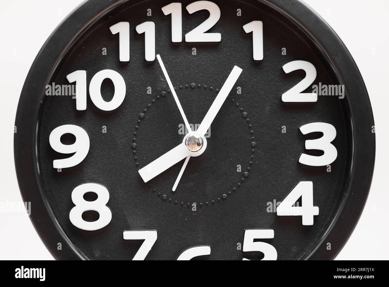 Close up black wall clock face white background Stock Photo - Alamy