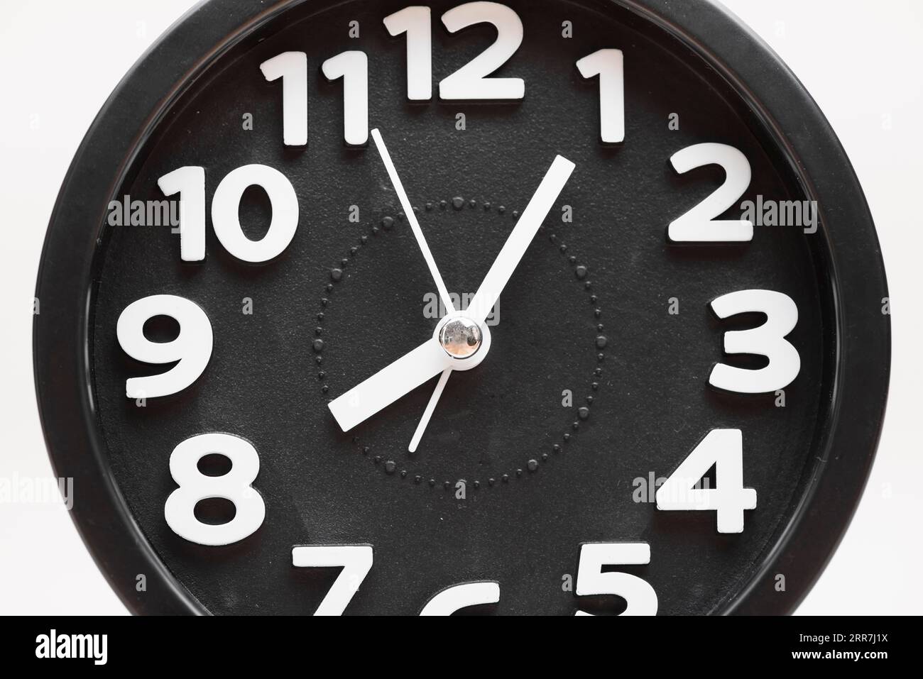 Close up black wall clock face white background Stock Photo Alamy