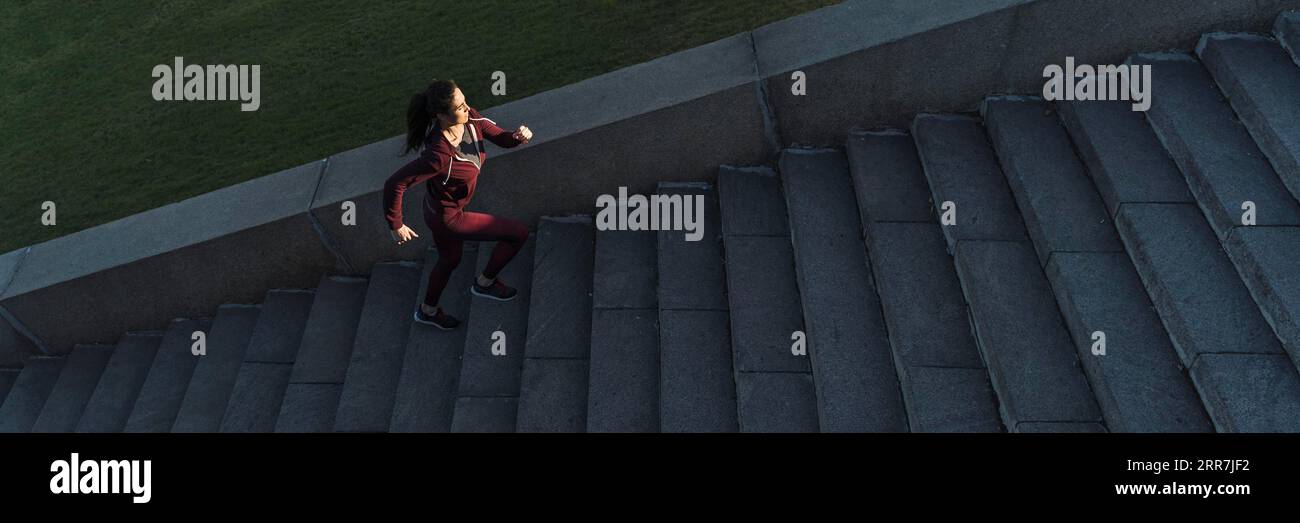 Fit young woman climbing stairs Stock Photo