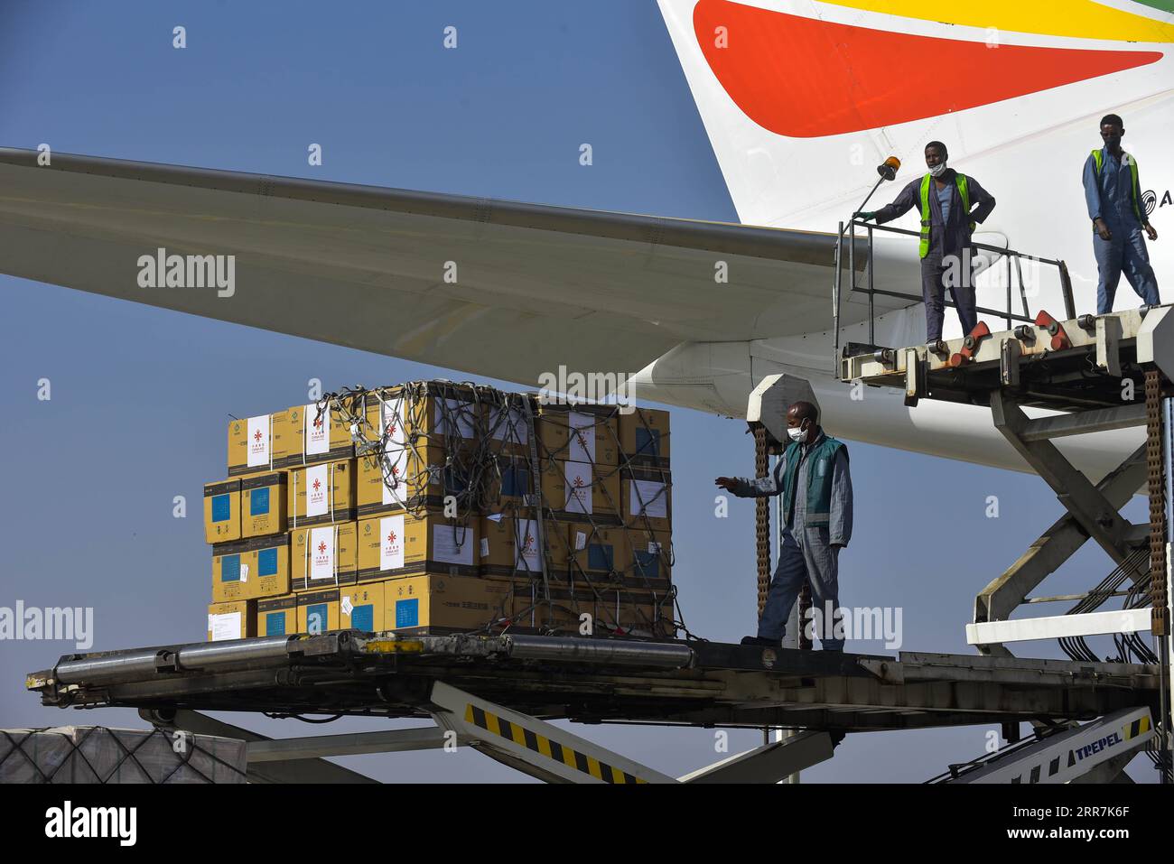 210330 -- ADDIS ABABA, March 30, 2021 -- Workers unload China s Sinopharm COVID-19 vaccines, donated by the Chinese government to Ethiopia, at the Addis Ababa Bole International Airport in Addis Ababa, Ethiopia, on March 30, 2021. Photo by /Xinhua ETHIOPIA-ADDIS ABABA-COVID-19-VACCINE-CHINA-DONATION MichaelxTewelde PUBLICATIONxNOTxINxCHN Stock Photo