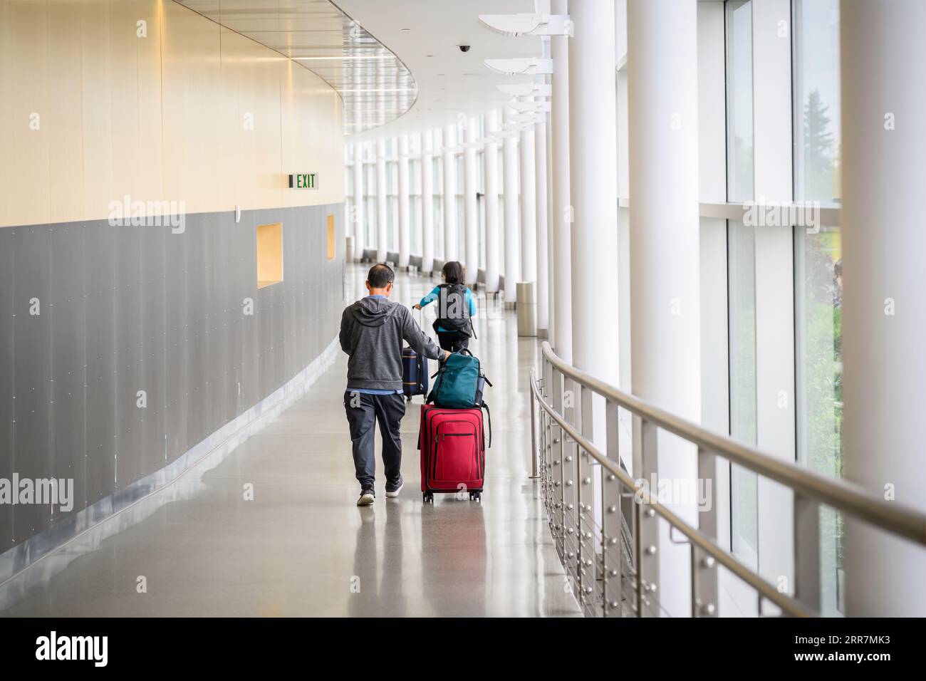Couple with luggage bags at the airport, ready to board the flight. Stock Photo