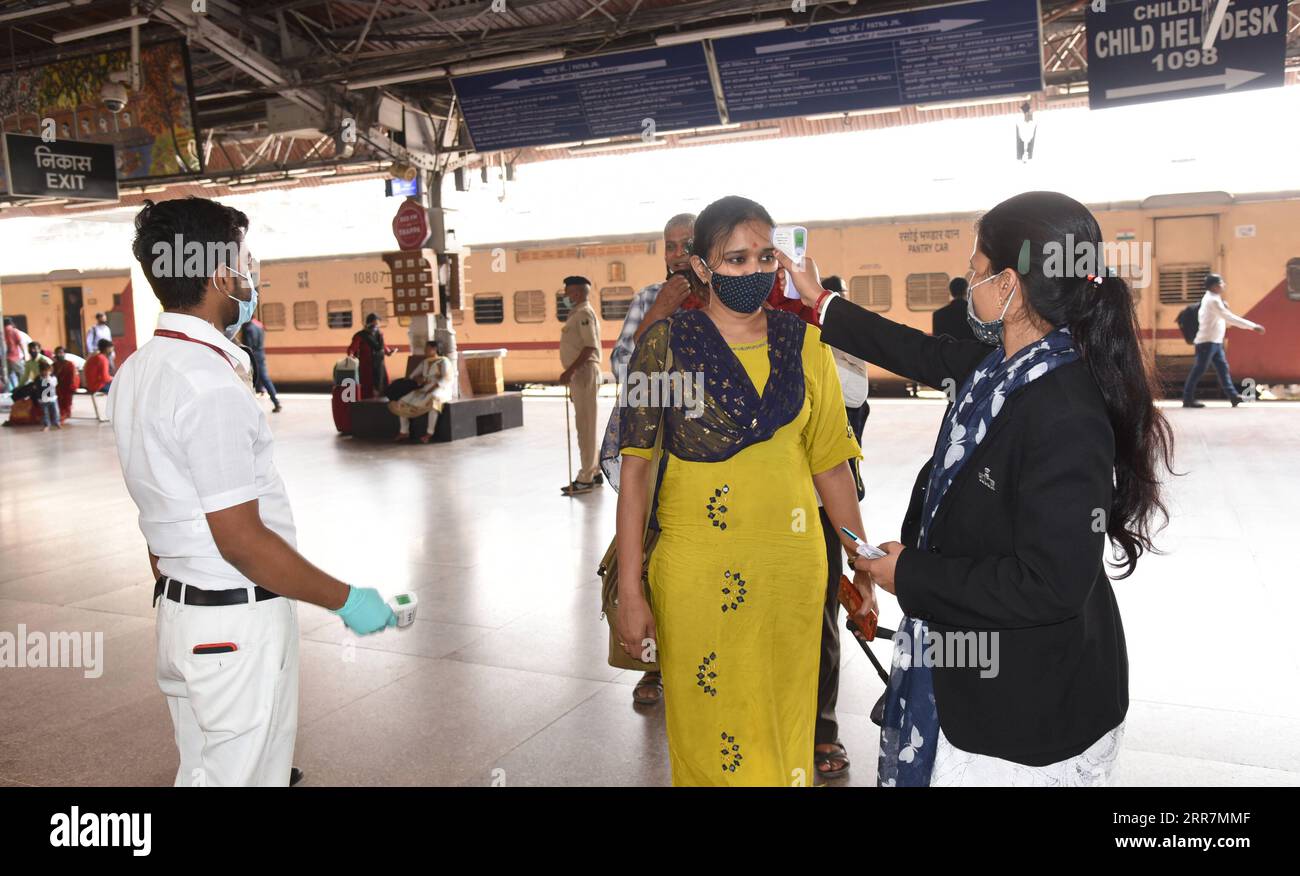 210331 -- PATNA, March 31, 2021  -- A health worker takes thermal screening of a passenger at a railway station in Patna, capital of eastern Indian state of Bihar, March 31, 2021. India s COVID tally rose to 12,149,335 on Wednesday as 53,480 new cases were reported from across the country, according to the latest figures released by the federal health ministry. Str/ INDIA-PATNA-COVID-19 Xinhua PUBLICATIONxNOTxINxCHN Stock Photo
