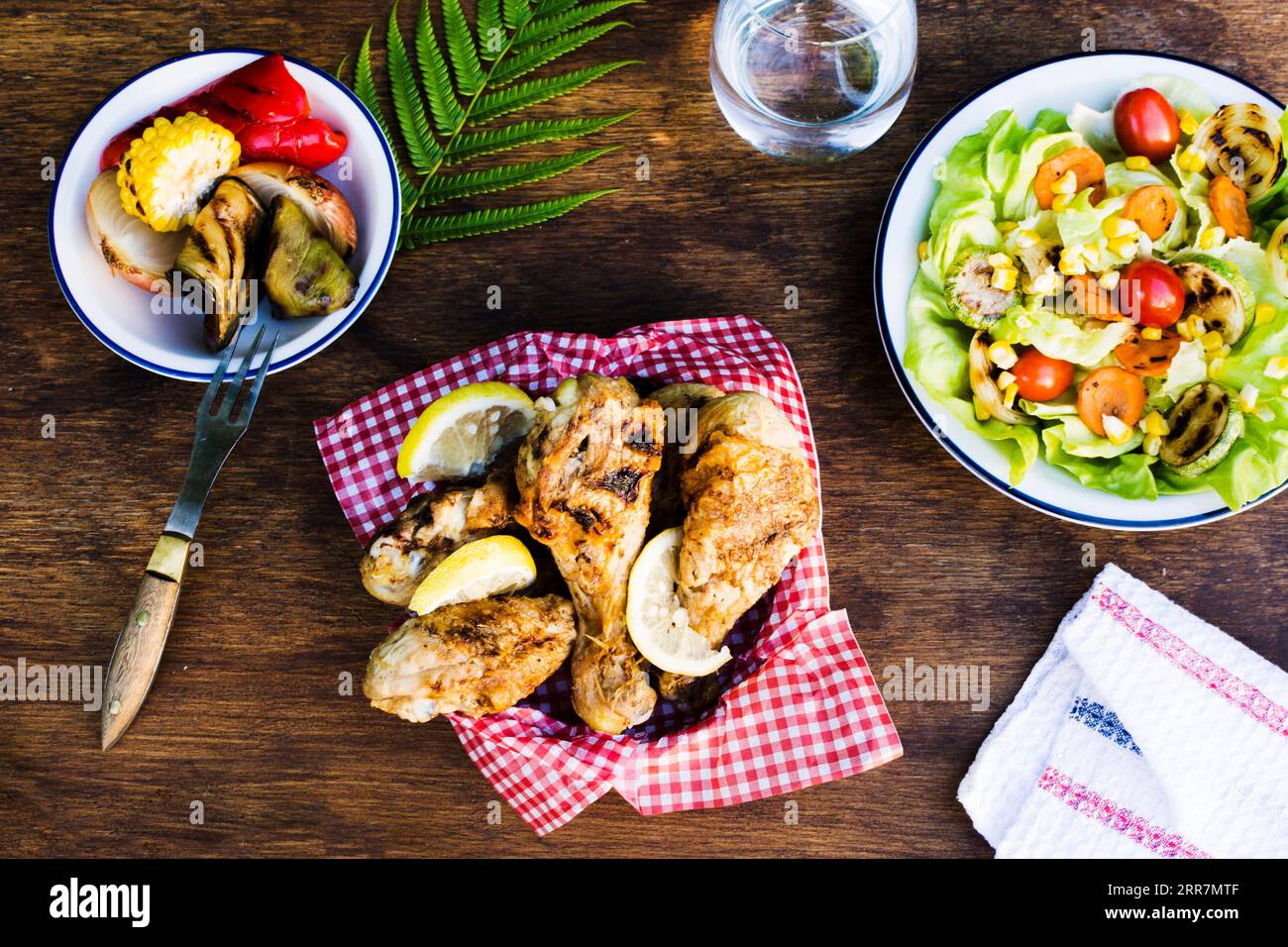 Grilled chicken legs with lemon salad Stock Photo