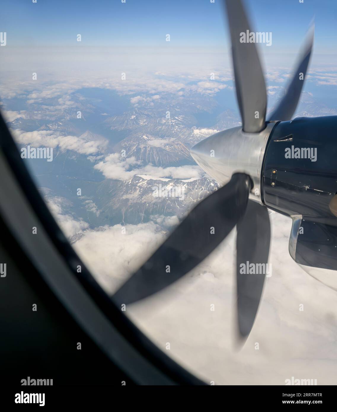 Aerial view of mountains from a small aircraft with a running propeller