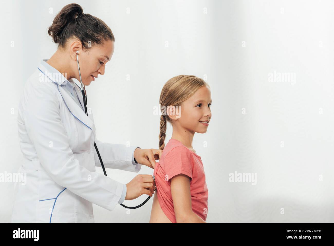 Medium shot doctor checking girl Stock Photo