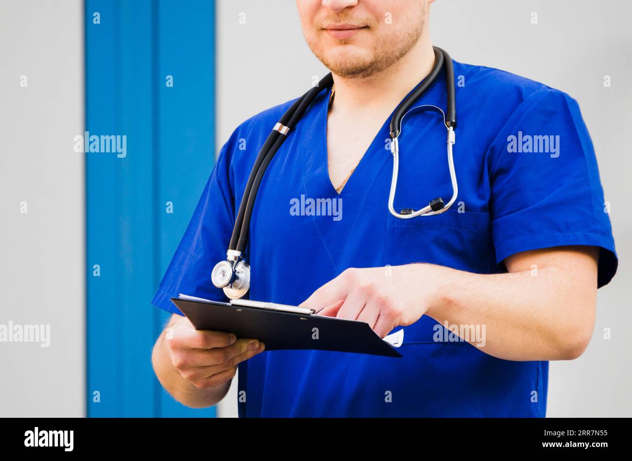Portrait male doctor with stethoscope around his neck examining medical