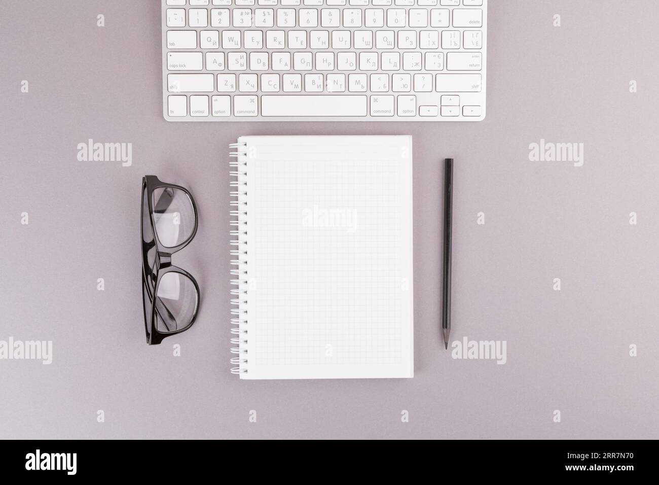 Pencil near notebook keyboard eyeglasses Stock Photo