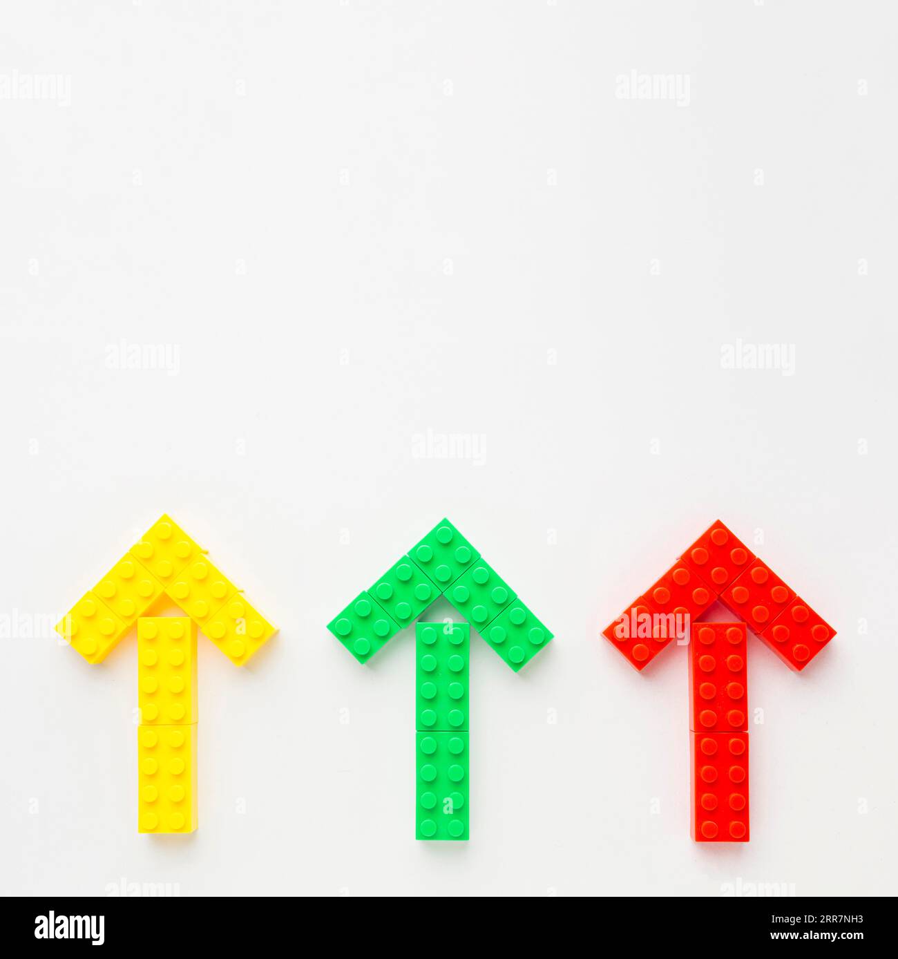 Top view colored toy arrows pointing up Stock Photo