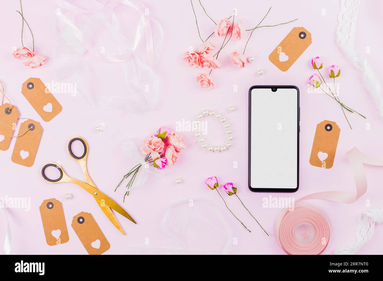 White screen display mobile phone with ribbons roses tags pearl pink