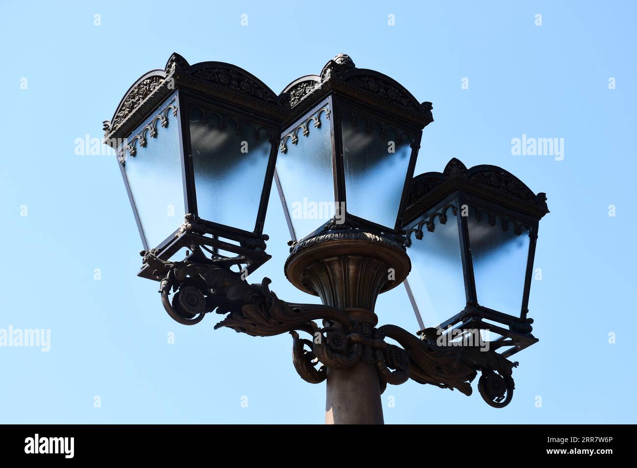 vintage style street light closeup. triple lantern. classic old cast