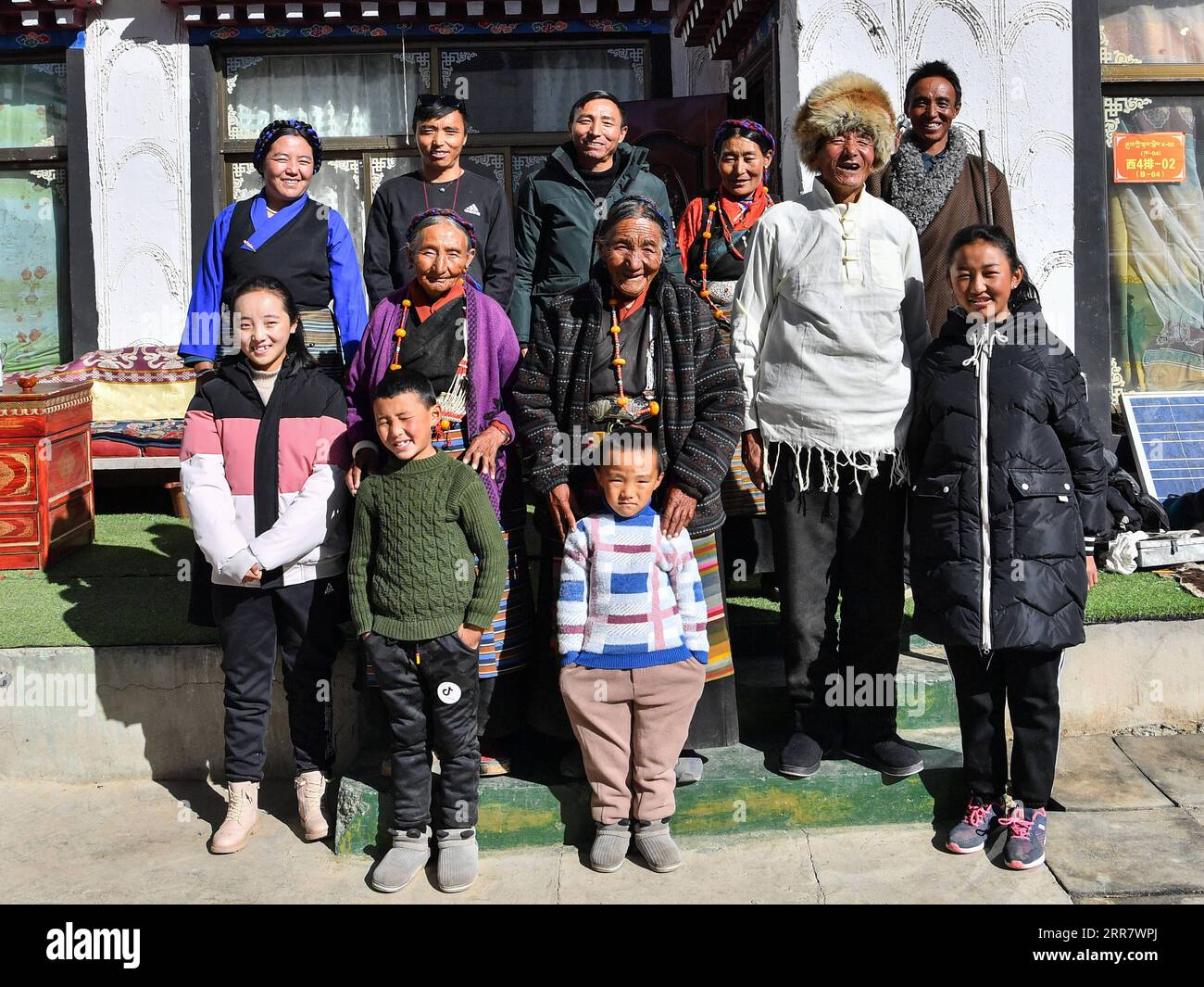 210406 -- LHASA, April 6, 2021 -- Dacho C poses for a photo with her family members at home in Lalho Township, Saga County of Xigaze, southwest China s Tibet Autonomous Region, Jan. 14, 2021. Dacho, born in 1929, is a resident in Lalho Township, Saga County of Xigaze, southwest China s Tibet Autonomous Region. She was made a serf in her early childhood and had suffered an unimaginable ordeal until the democratic reform in 1959. The serf owner kept a roster listing dates of birth of all local residents, who would be made serfs at certain age, regardless of gender or health condition, Dacho reca Stock Photo
