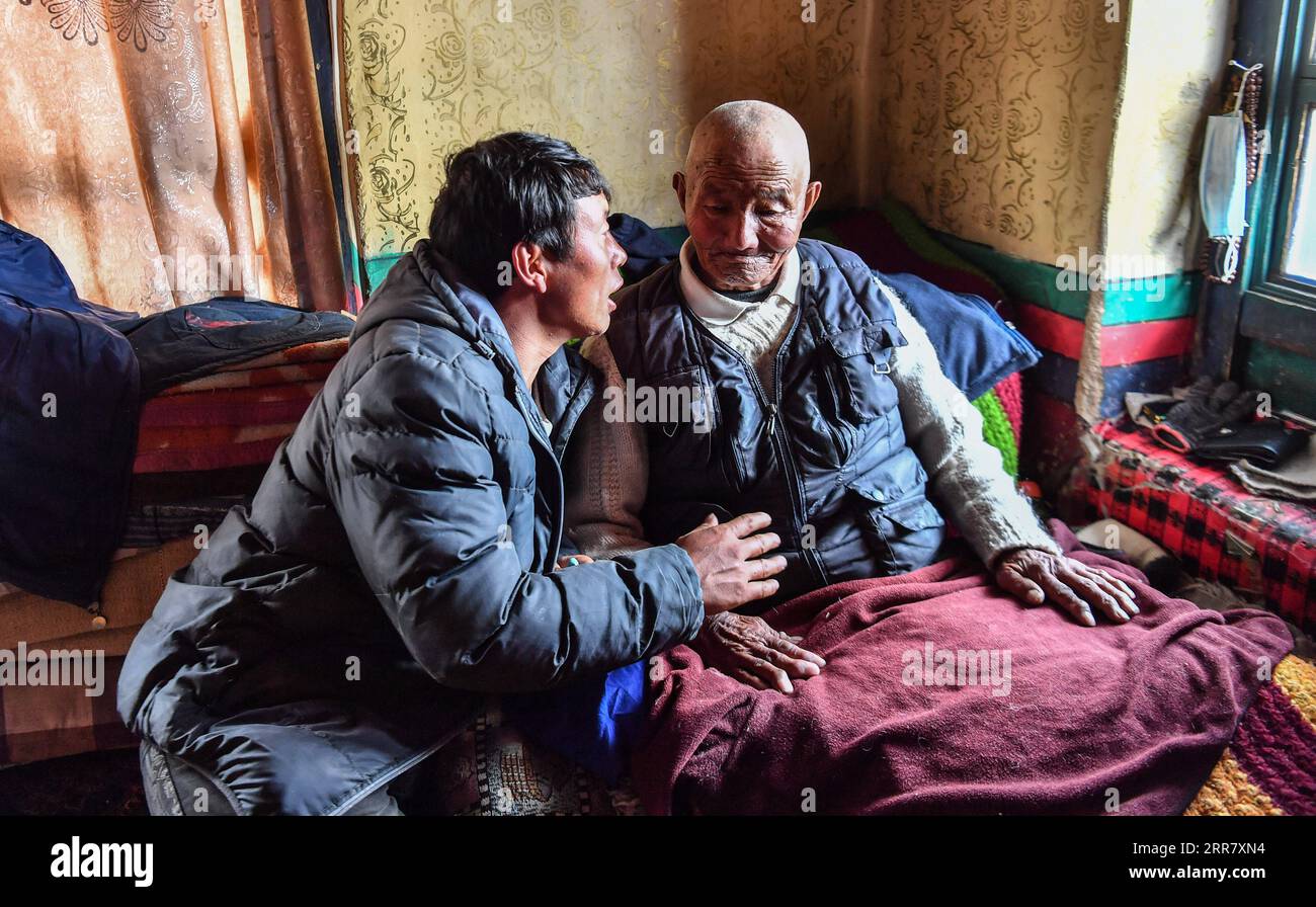 210407 -- LHASA, April 7, 2021 -- Photo taken on March 22, 2021 shows Tsephel R chatting with his son-in-law at home in Qangka Township of Lhasa, capital of southwest China s Tibet Autonomous Region. Tsephel, 92 years old, lives in Qangka Township of Lhunzhub County of Lhasa. Born in Gyaca County of Shannan, he was born into serfdom at birth. He and his parents had been leading a life often without enough food and in ragged clothes. After his parents died, Tsephel had to start a roving life to avoid being caught by serf owners. Once we had been caught by serf owners, they would likely gouge ou Stock Photo