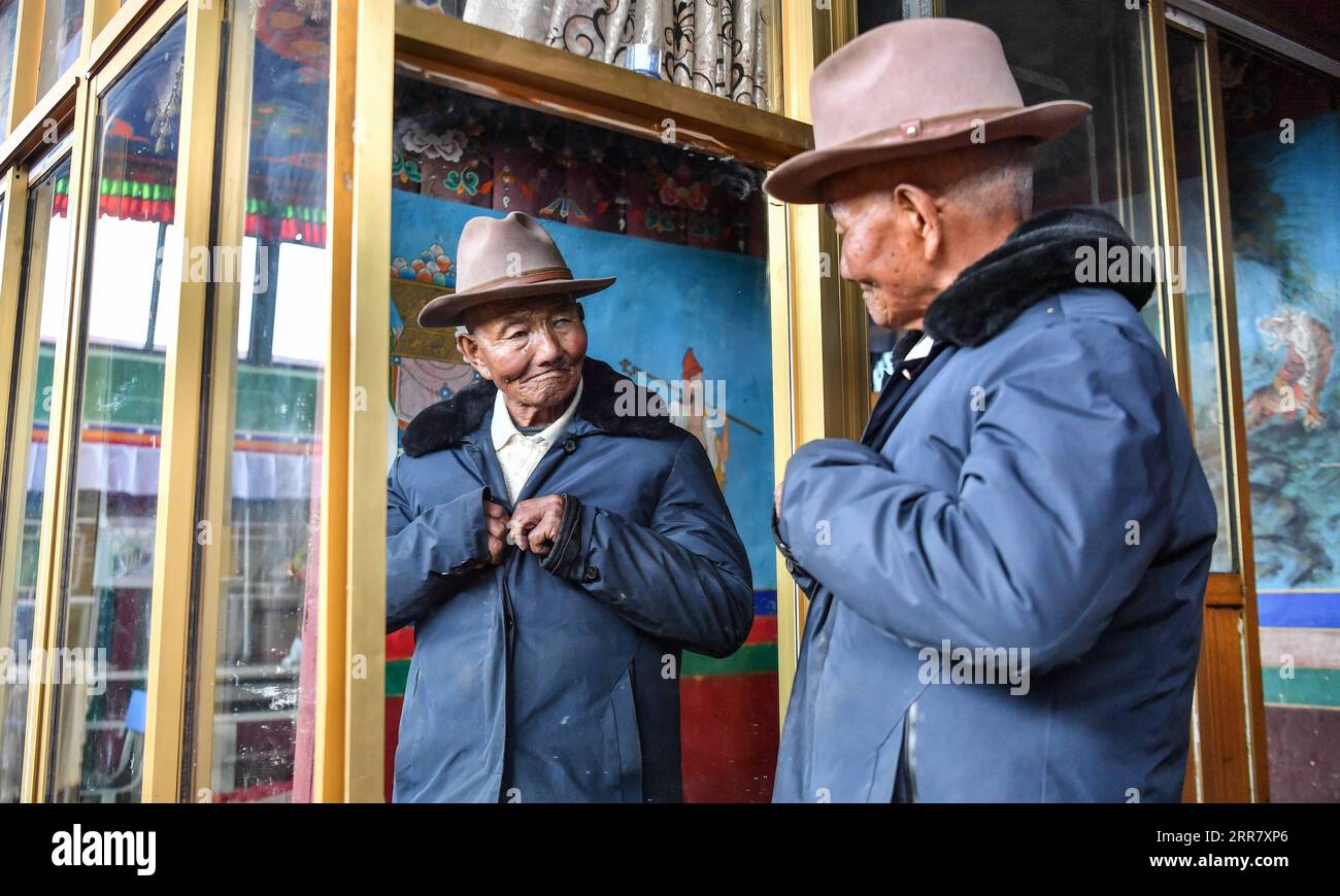 210407 -- LHASA, April 7, 2021 -- Photo taken on March 22, 2021 shows Tsephel wearing his clothes at home in Qangka Township of Lhasa, capital of southwest China s Tibet Autonomous Region. Tsephel, 92 years old, lives in Qangka Township of Lhunzhub County of Lhasa. Born in Gyaca County of Shannan, he was born into serfdom at birth. He and his parents had been leading a life often without enough food and in ragged clothes. After his parents died, Tsephel had to start a roving life to avoid being caught by serf owners. Once we had been caught by serf owners, they would likely gouge out our eyes, Stock Photo