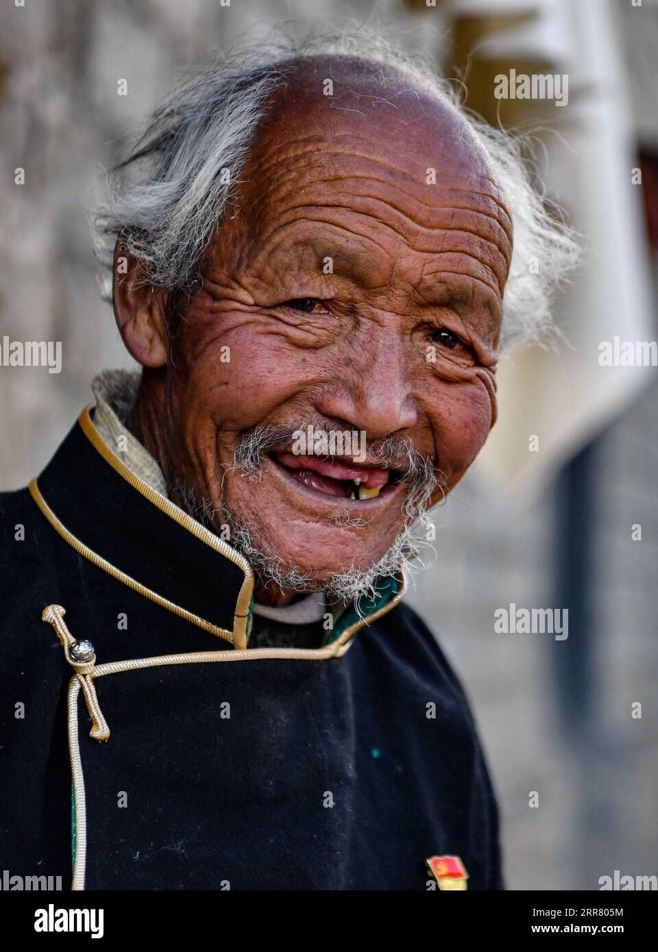 210410 -- LHASA, April 10, 2021 -- Dawa Gokye poses for a photo in Gyadu Village of Jangra Township in Gyangze County of Xigaze City, southwest China s Tibet Autonomous Region, March 22, 2021. Dawa Gokye, 76, once a serf in a local manor of Tibet, had lived in hopelessness and despair until the democratic reform in 1959. In the eyes of the serf owners, serfs are nothing but talking tools at their mercy. Dawa recalled his head was hurt badly by the steward of the manor, as the then 8-year-old didn t boil the water hot while brewing the tea. Together with tens of thousands of other serfs, Dawa e Stock Photo